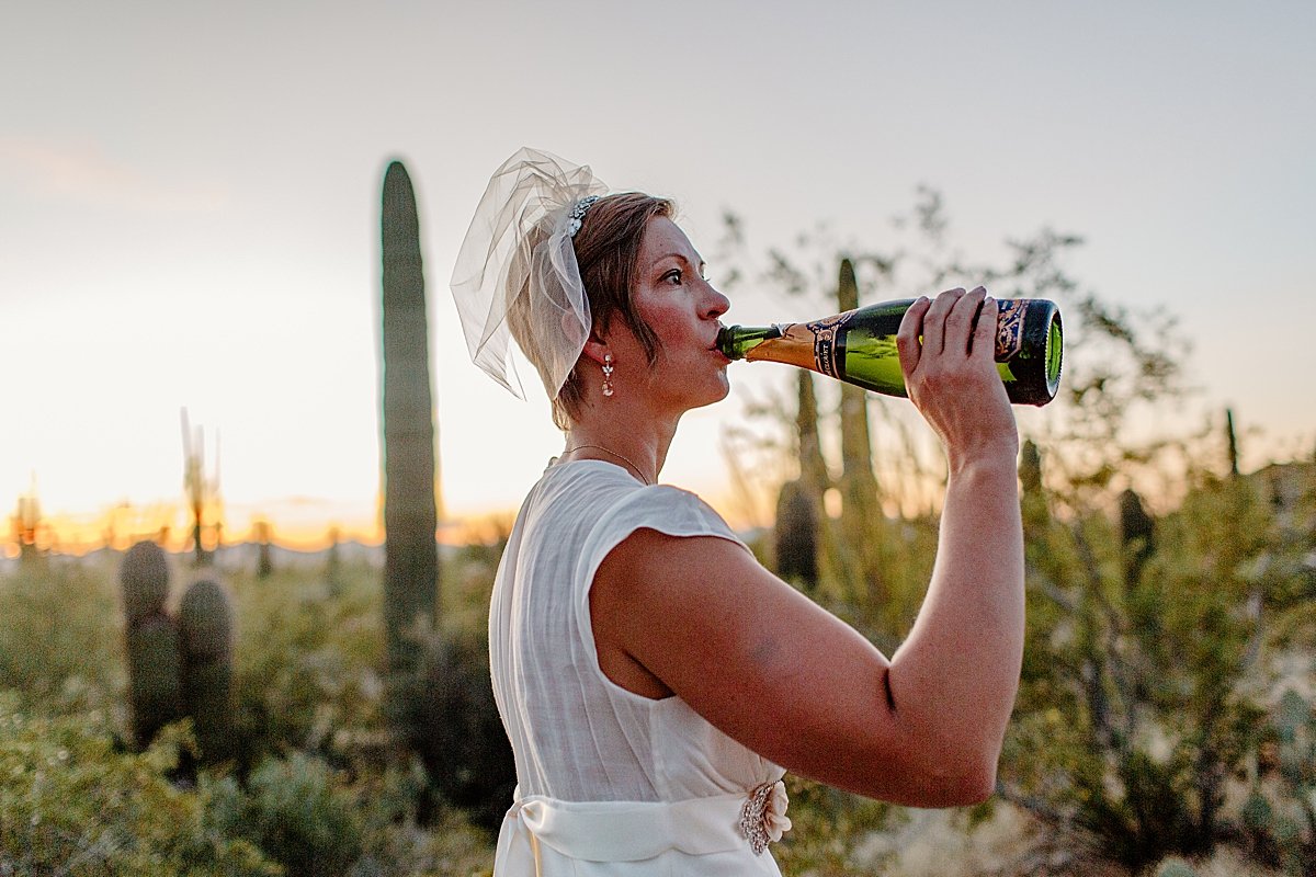  Bride enjoys bottle of champagne by Tucson Elopement photographer 