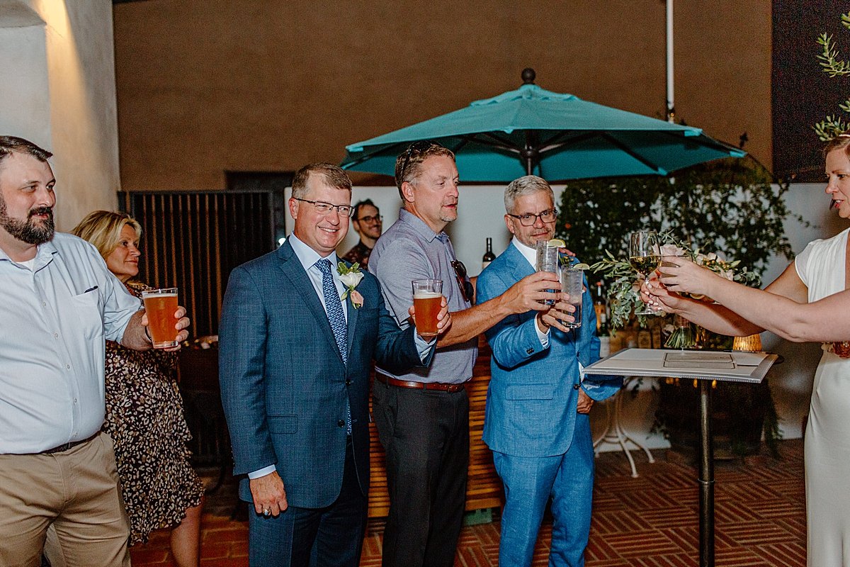  Guests share a toast at micro wedding by Tucson Elopement photographer 