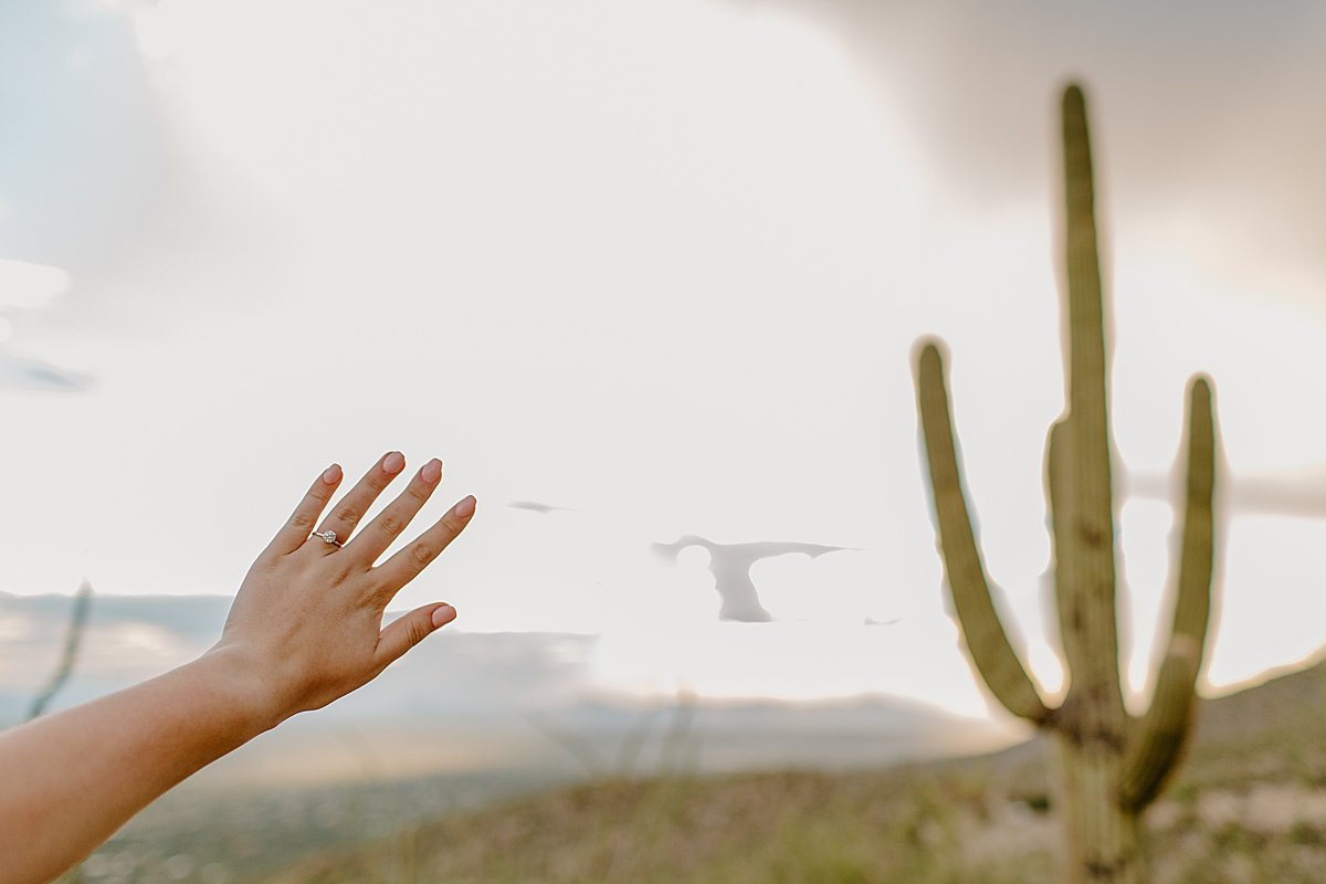  ring shown off on hand reaching out by Arizona engagement photographer 