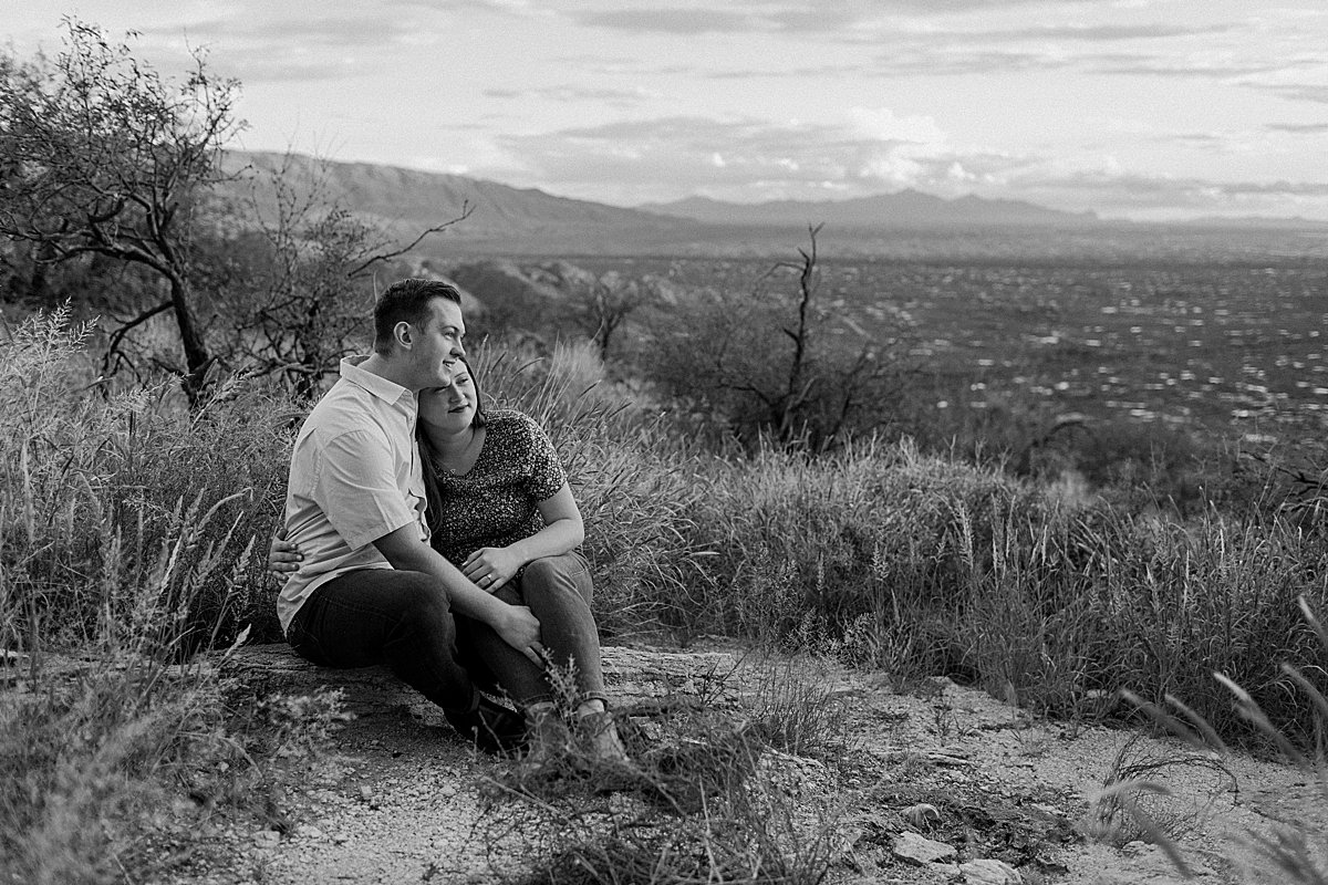  couple sits close on rocks at  Mount Lemmon session 