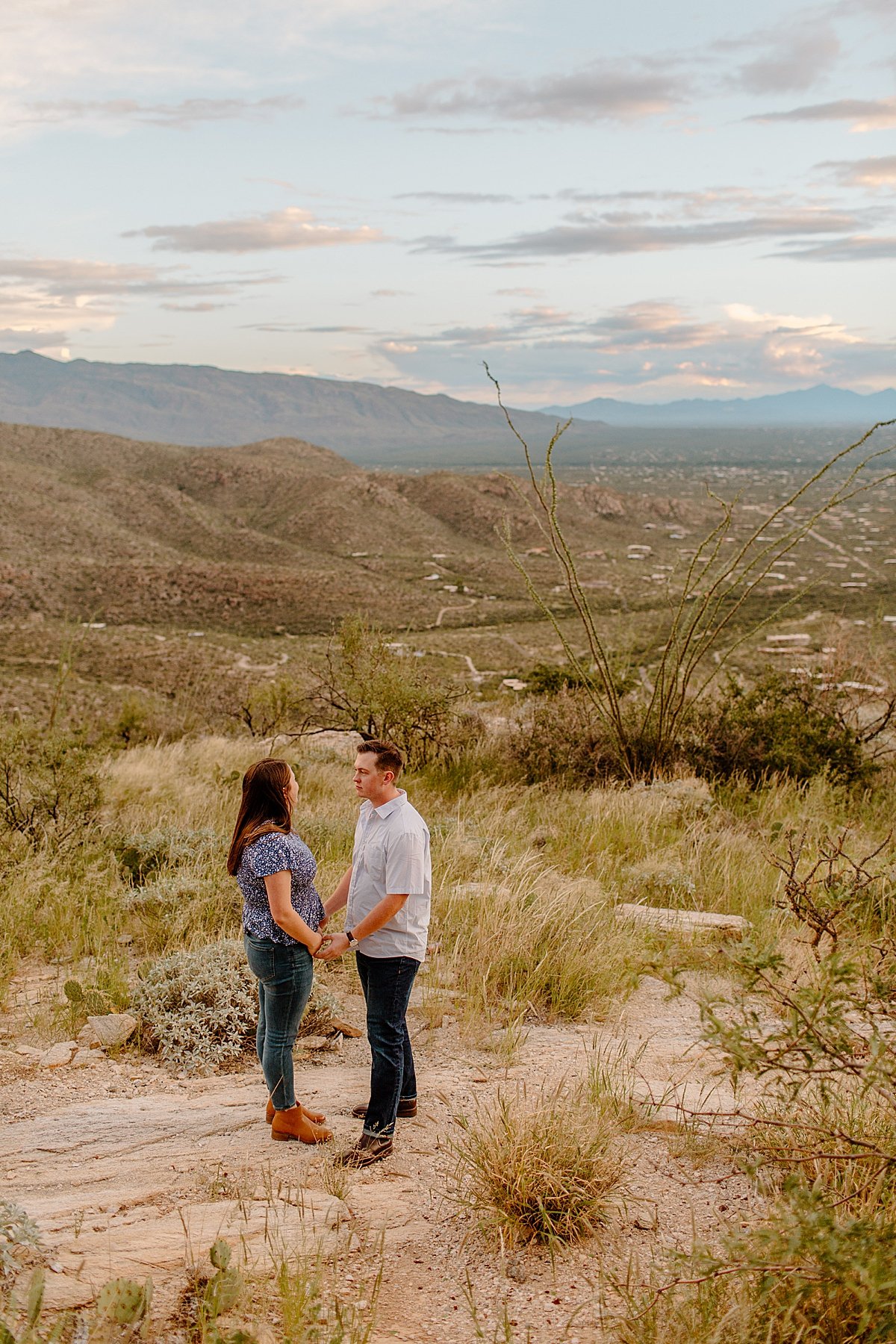  couple holds hands and faces each other at  Mount Lemmon session 