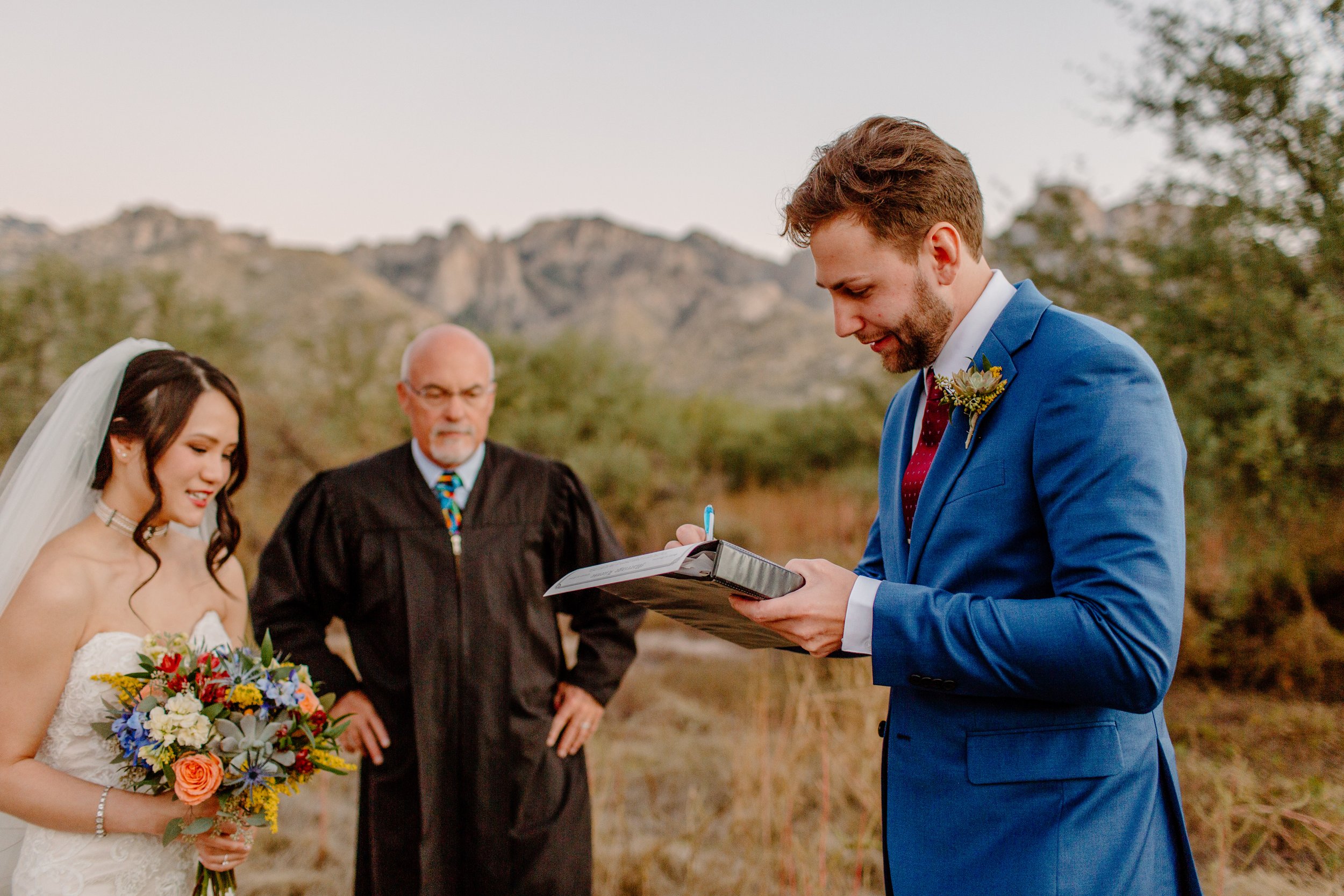  groom signs marriage license wearing blue suit by Lucy bouman photo 