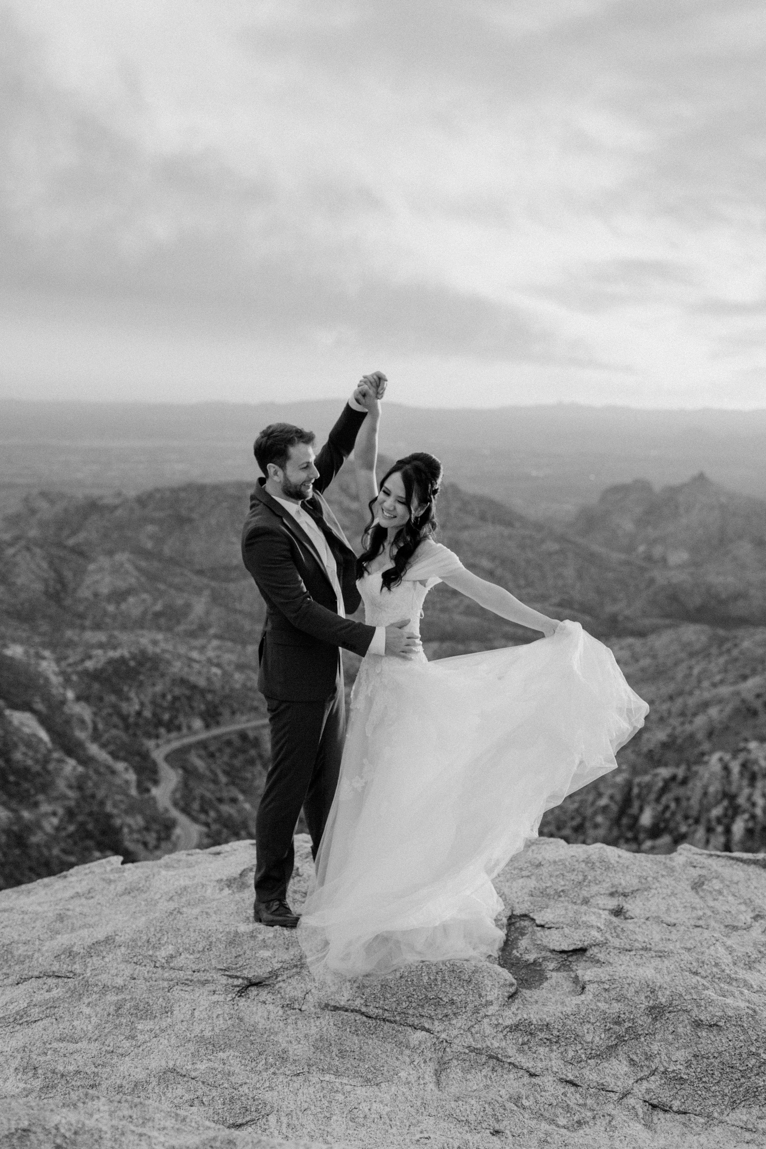  bride twirling around with wedding dress train by Arizona elopement photographer  