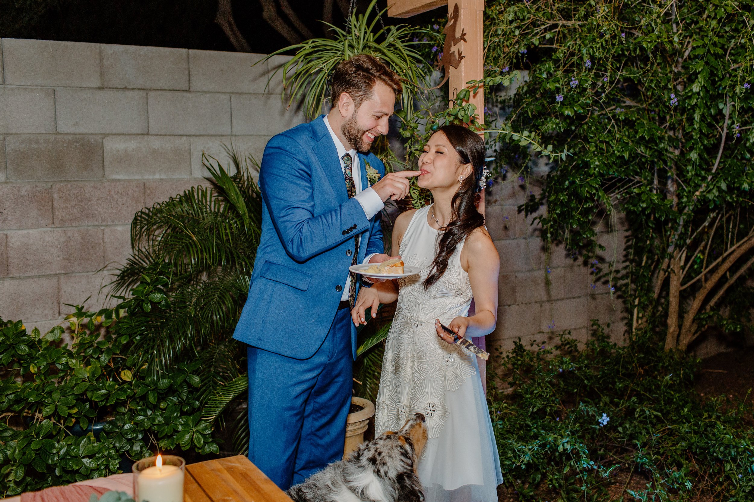  husband and wife eating wedding cake at reception by Lucy bouman photo 