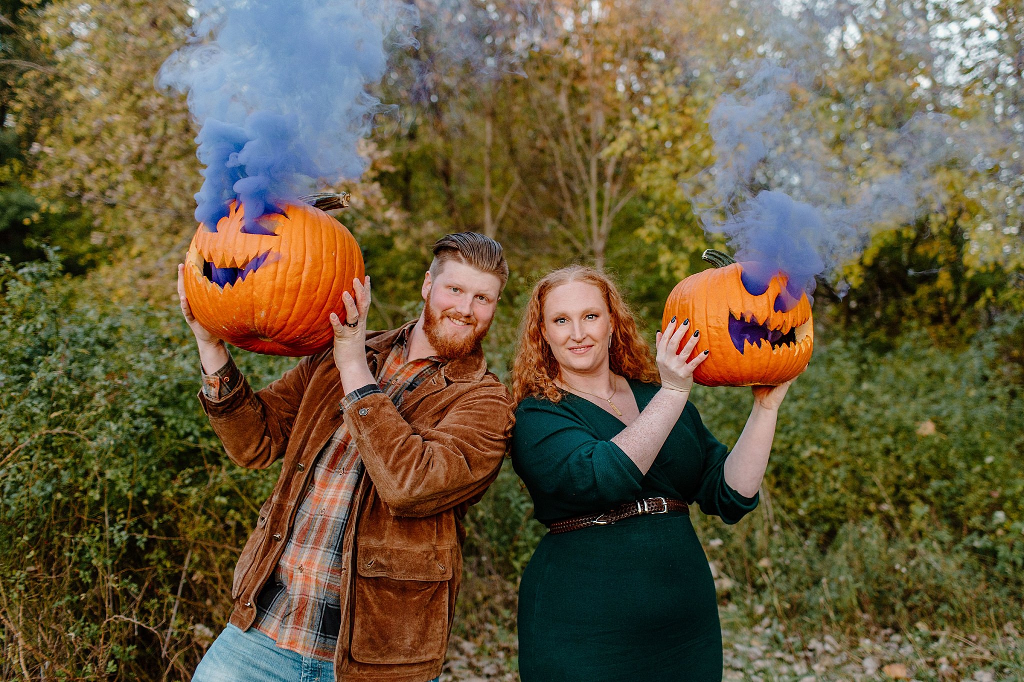  fiances peek out from behind smoking pumpkins for Lucy B Photography 