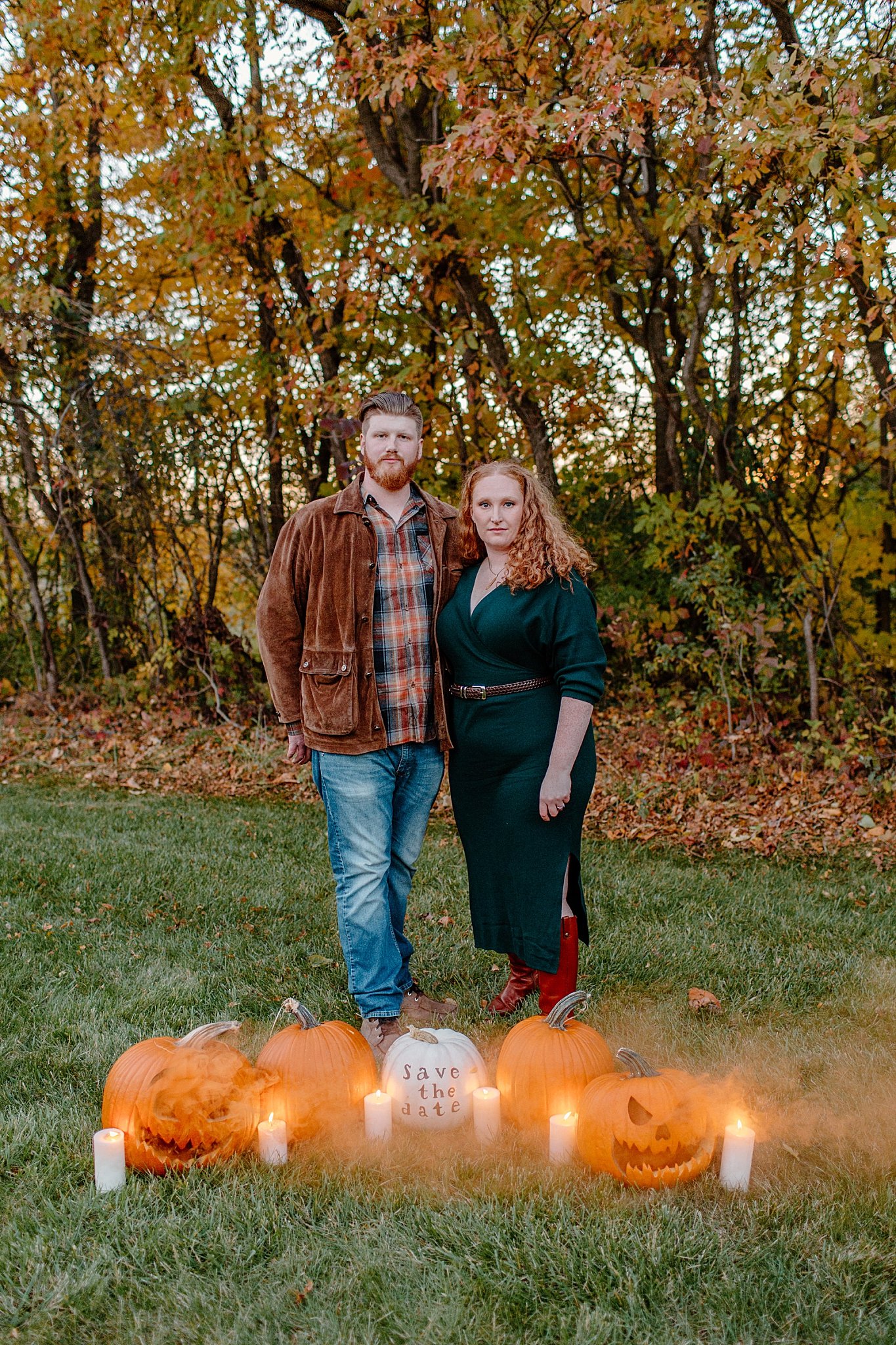  couple stands behind pumpkins by Arizona elopement photographer 