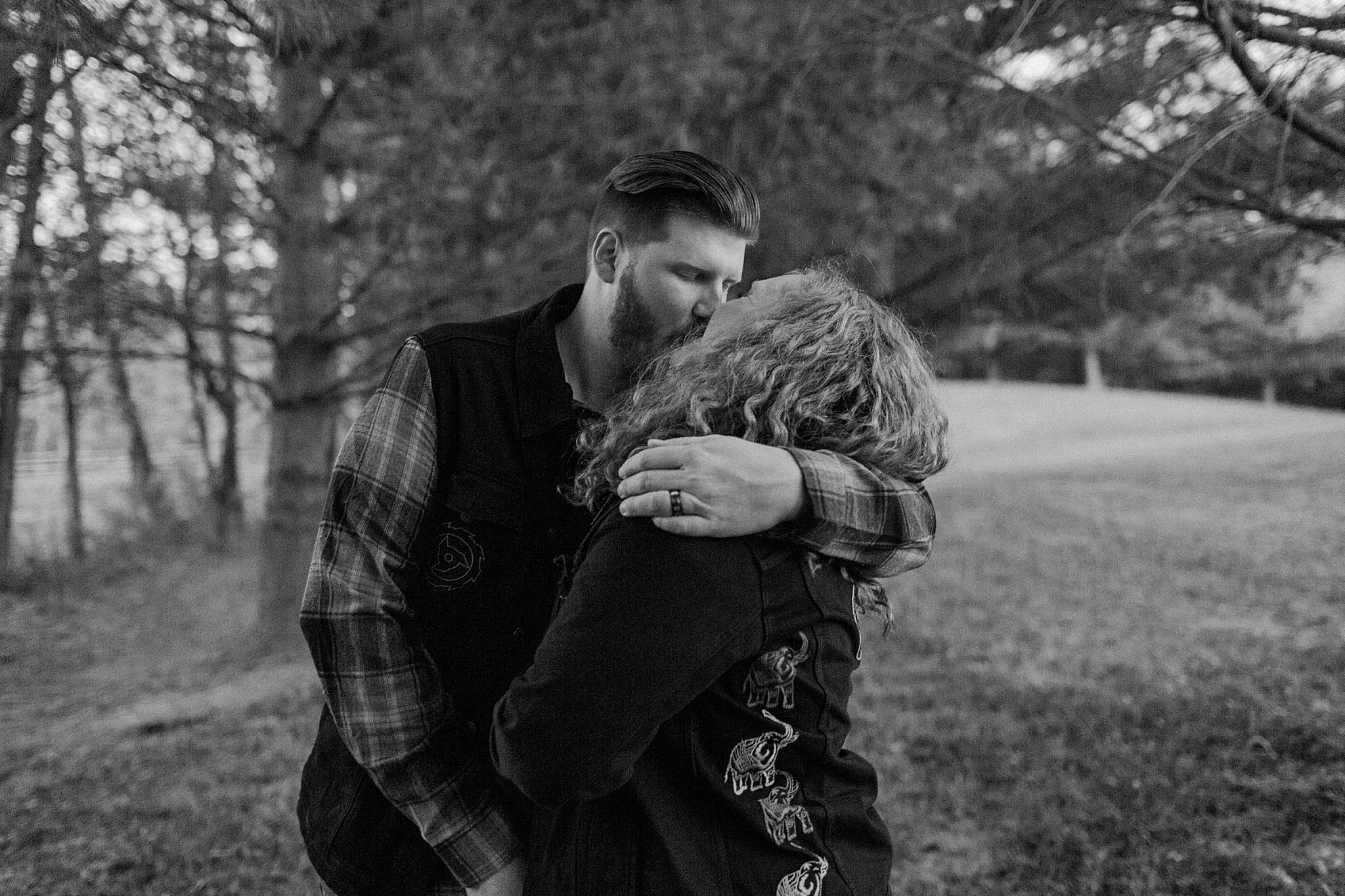  Man and woman kiss at Halloween engagement session 