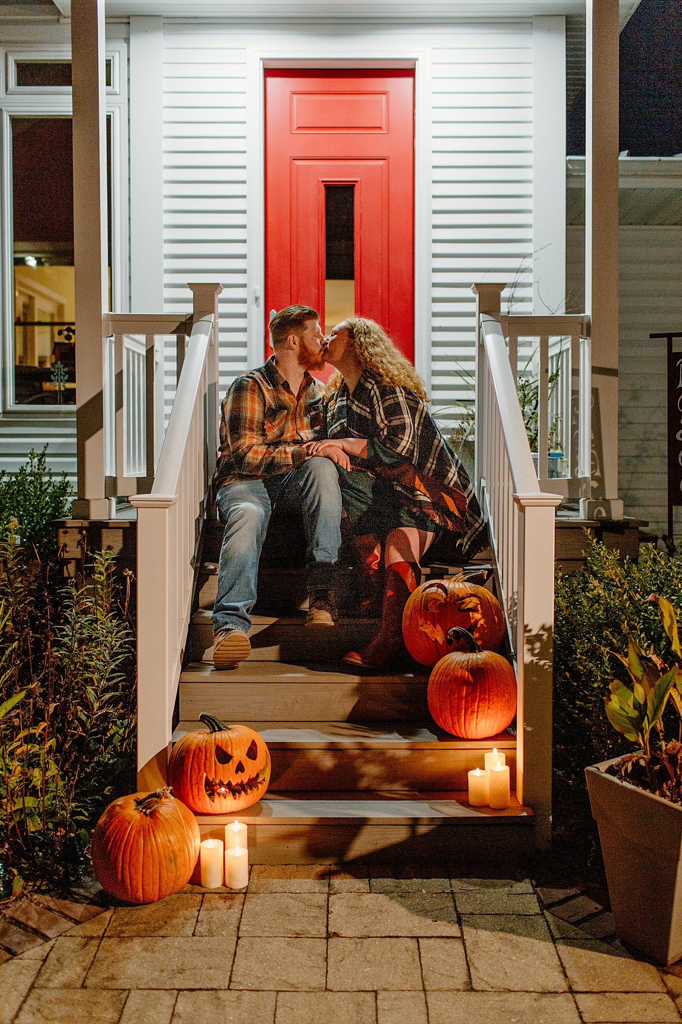  fiances kiss on steps with pumpkins by Lucy B Photography 