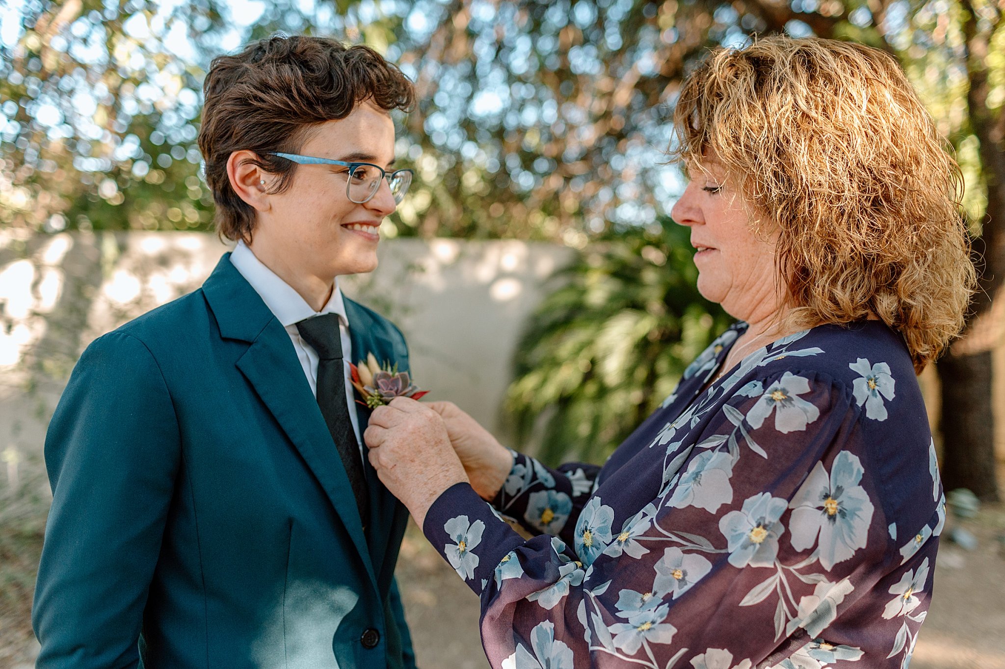  mother pins boutonniere on by Arizona wedding photographer 