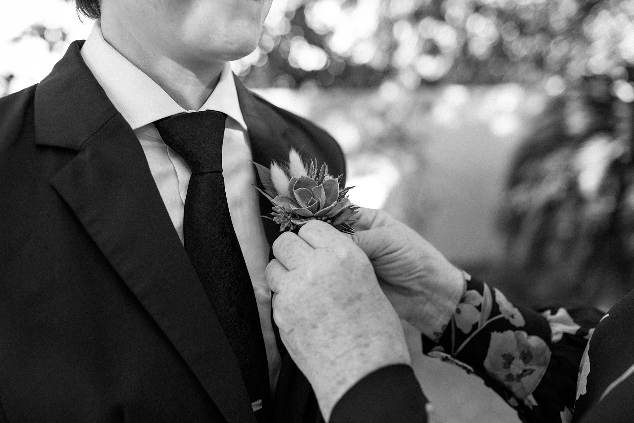  boutonniere is pinned on by Lucy B Photography 