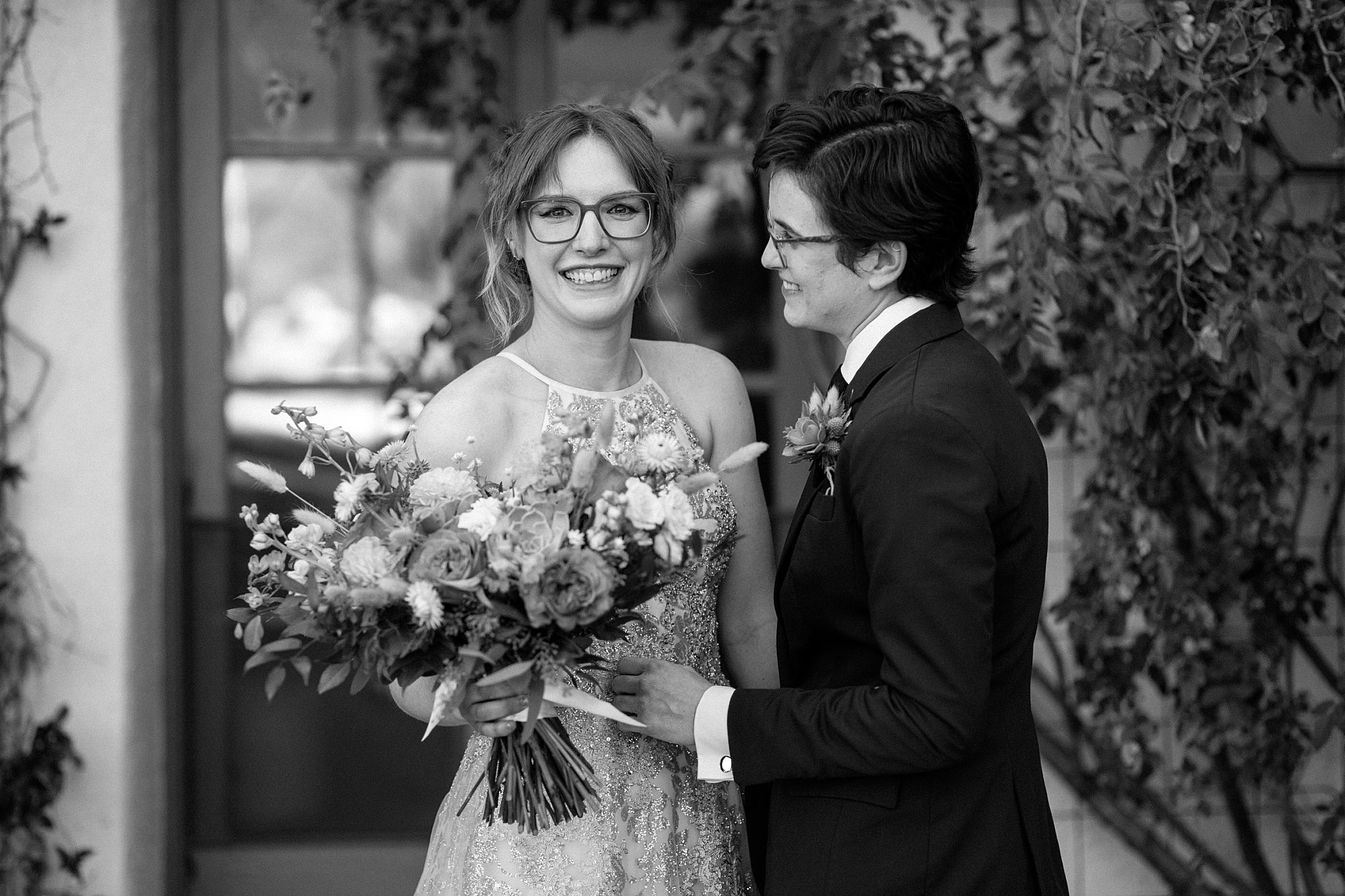  partner looks at bride by Arizona wedding photographer 