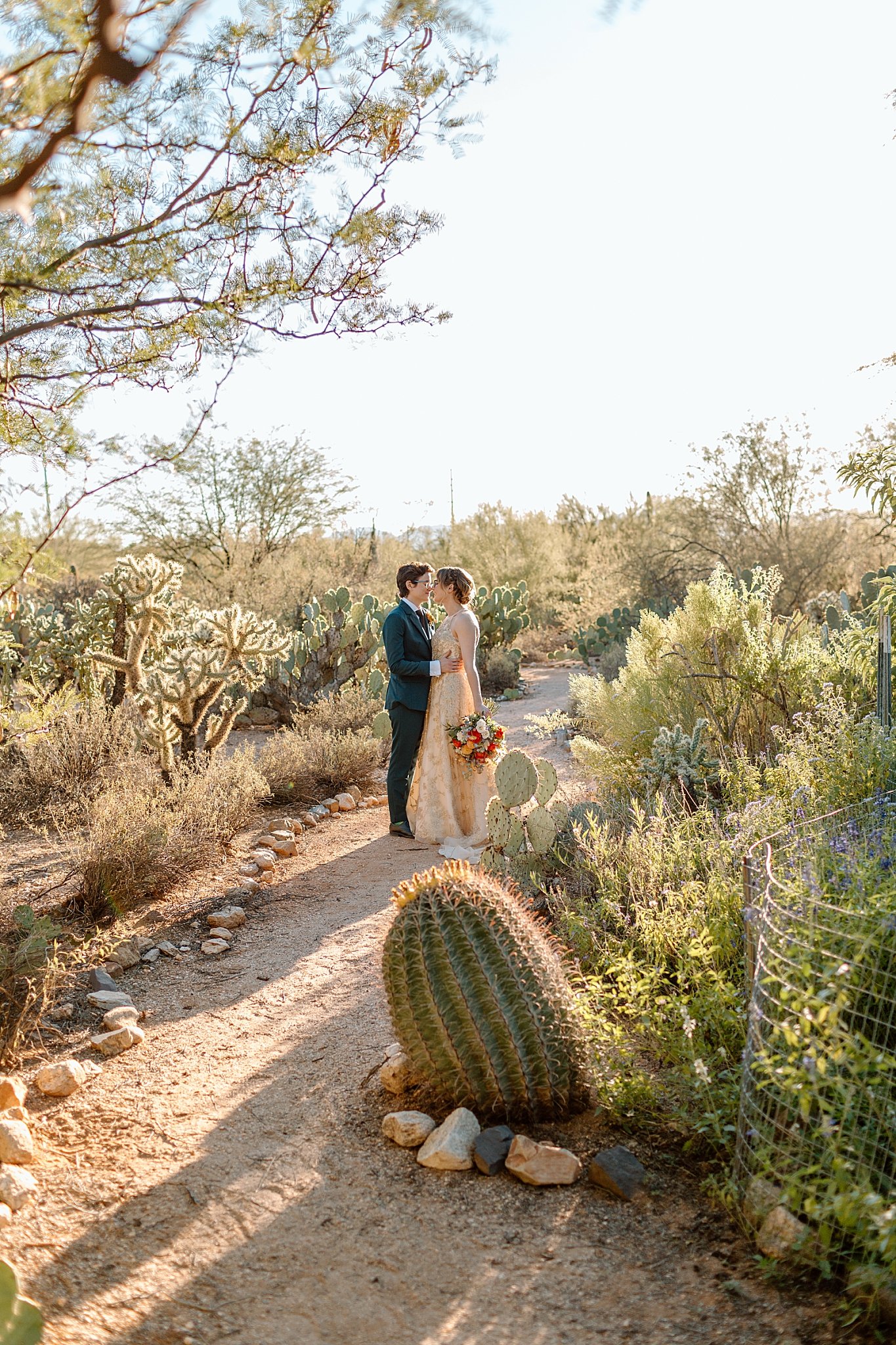  couple stands on path at Tucson botanical gardens ceremony 