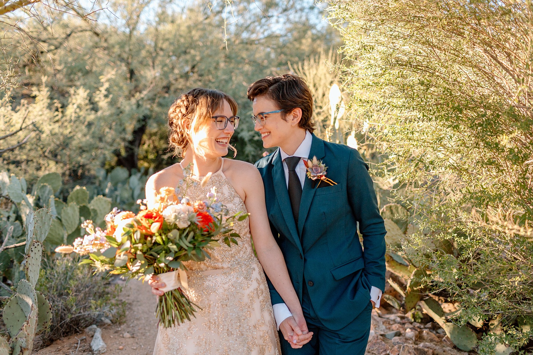  newlyweds hold hands by Arizona wedding photographer 