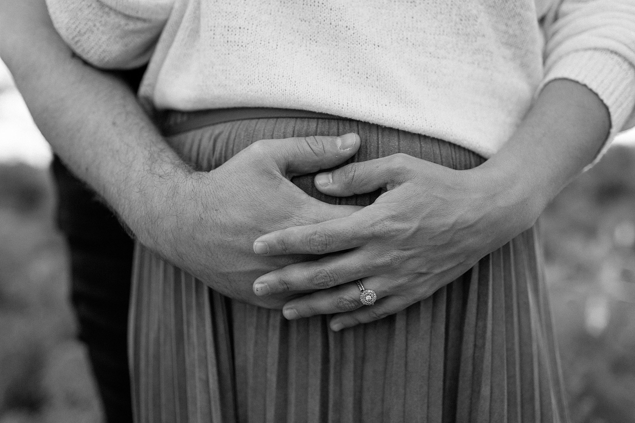  hands hold bump of mother-to-be by Lucy B Photography 