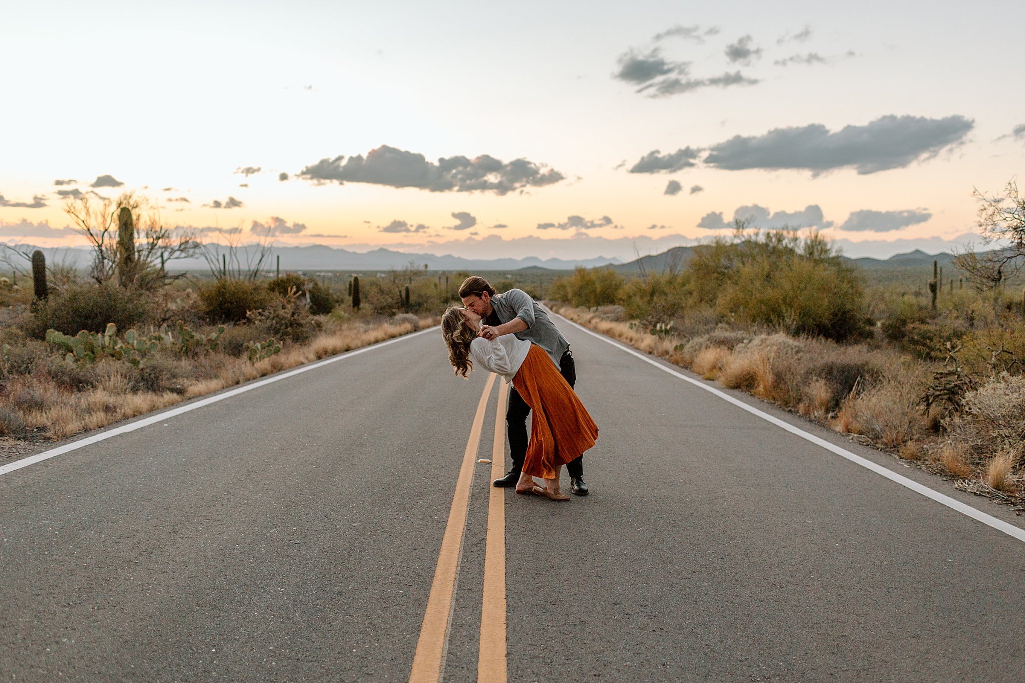  man dips and kisses woman in road by Lucy B Photography 