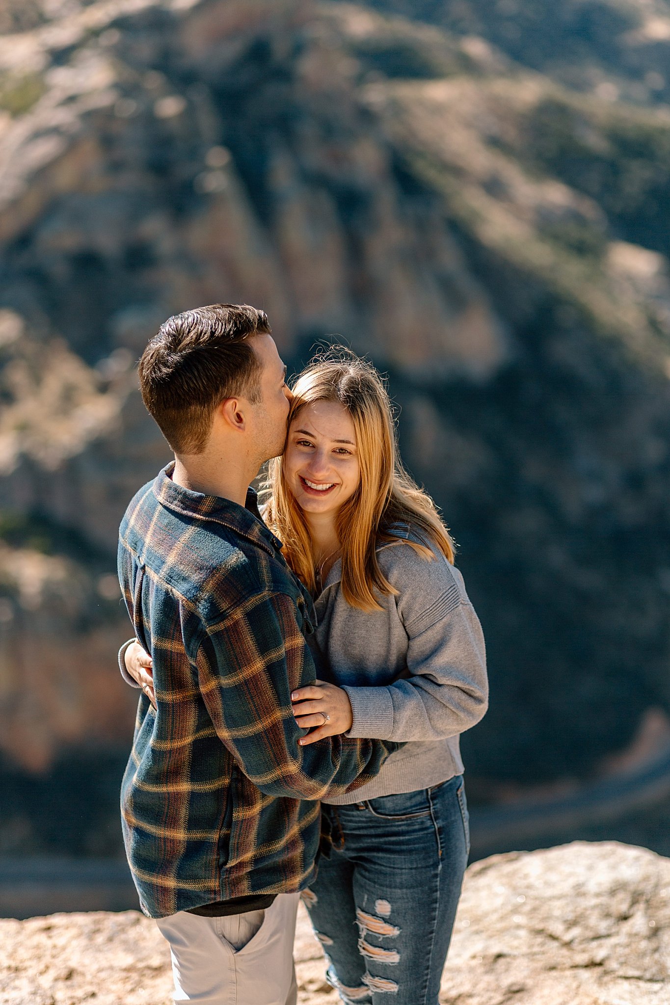  couple hug each other close by Arizona engagement photographer 