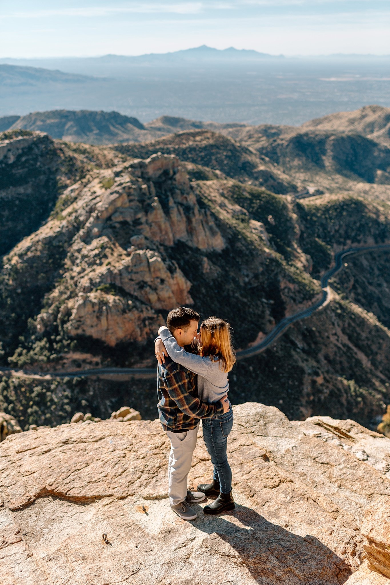  man and woman kiss on rocks at Mount Lemmon proposal 