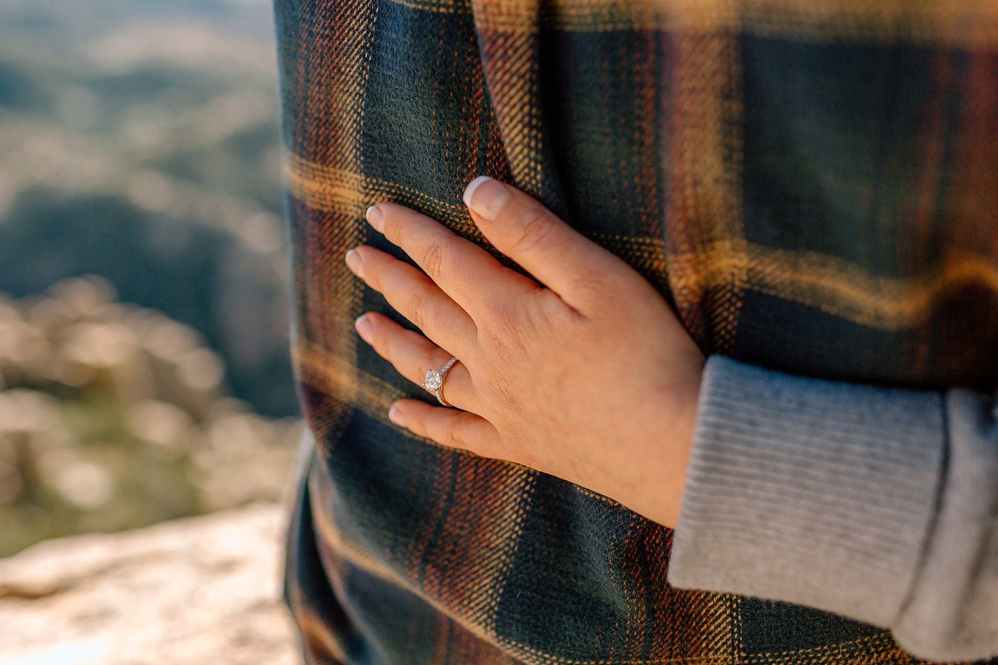  new ring on woman’s hand as she hugs man at Mount Lemmon proposal 