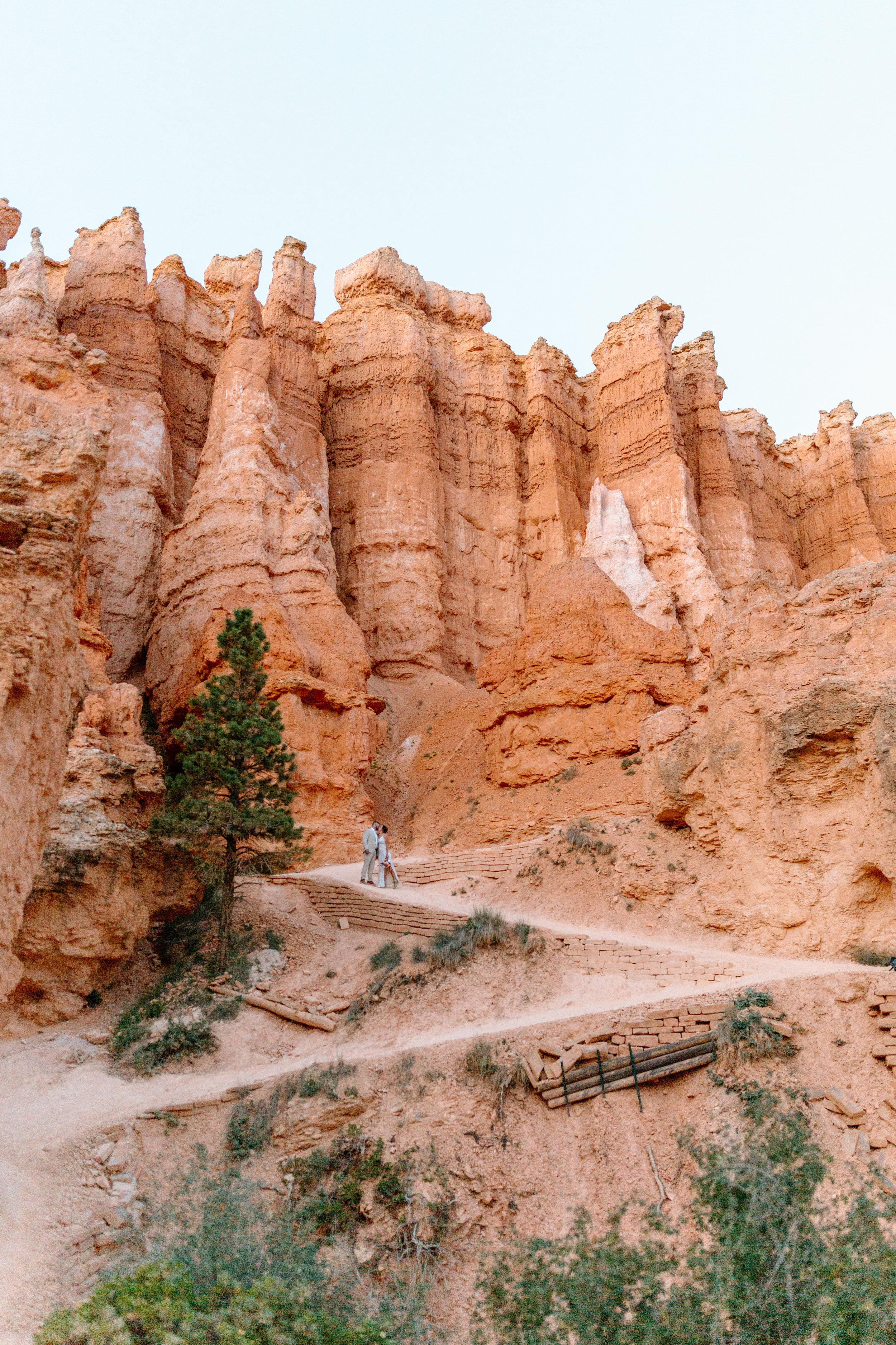  couple kisses on switchback trail in front of large hoodoos during bryce canyon national park elopement 