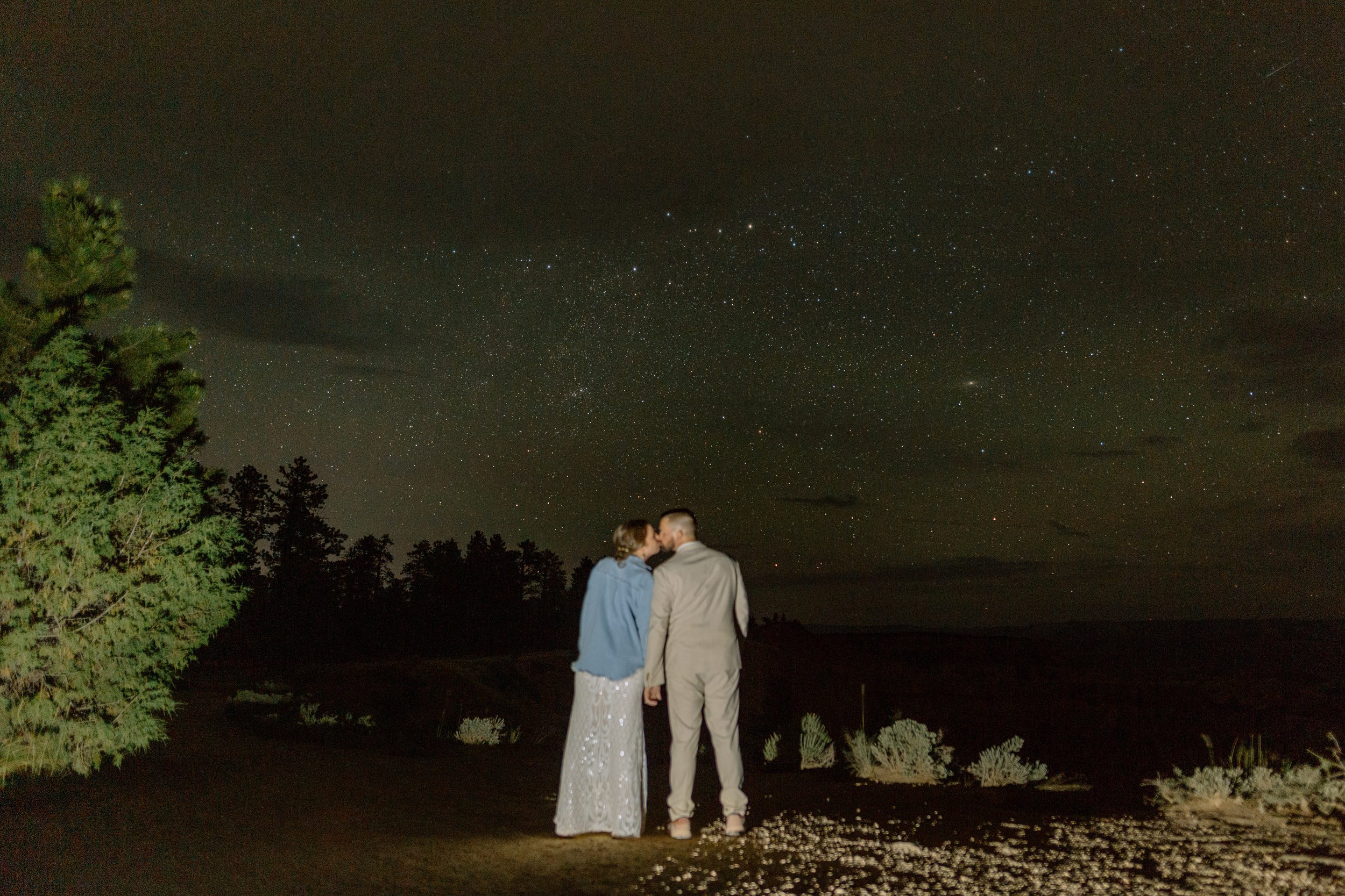  couple kisses in front of night stars by utah elopement photographer 