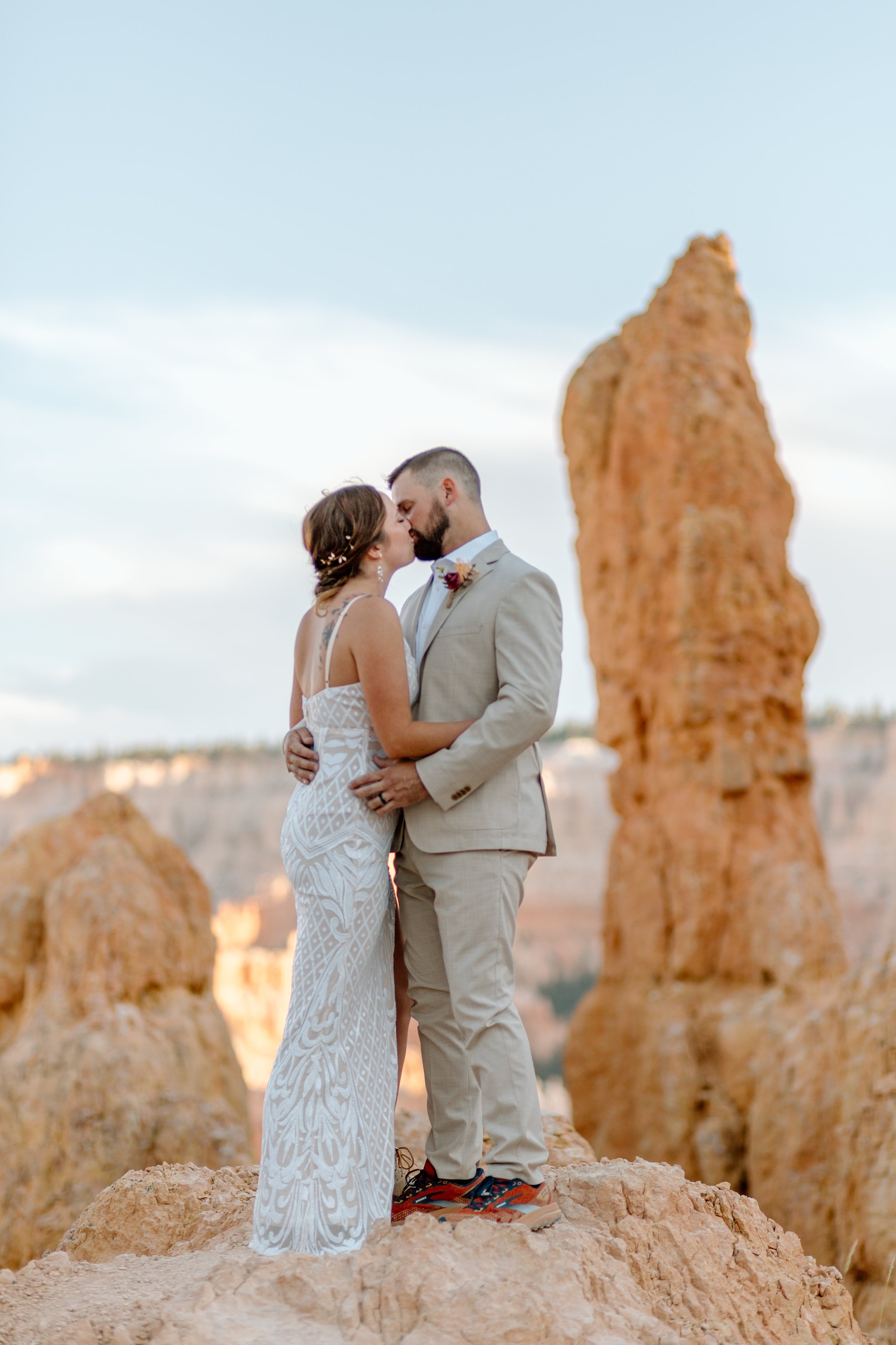  couple kisses while standing among hoodoos at bryce canyon national park by utah elopement photographer 