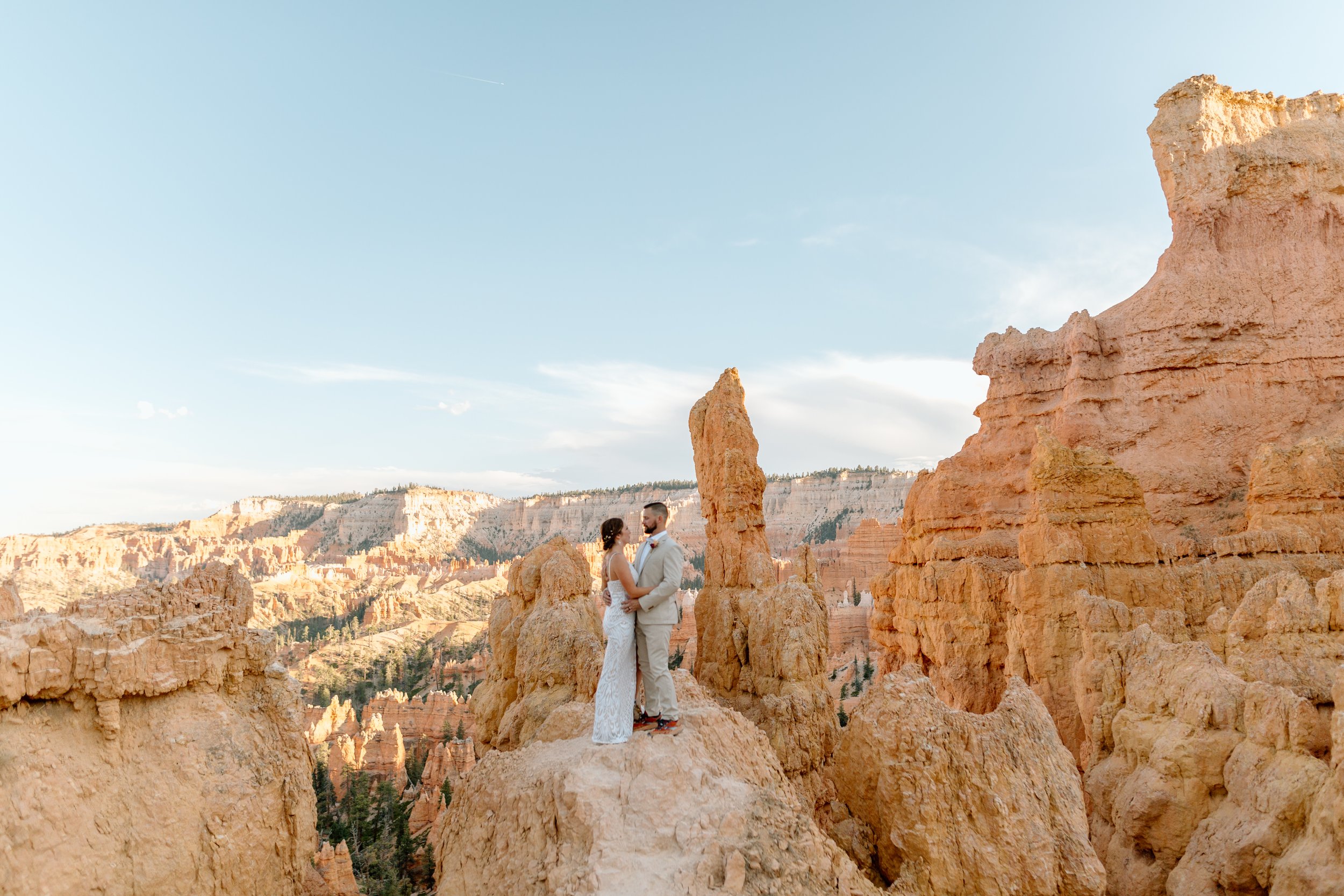  couple stands among hoodoos during their bryce canyon elopement 