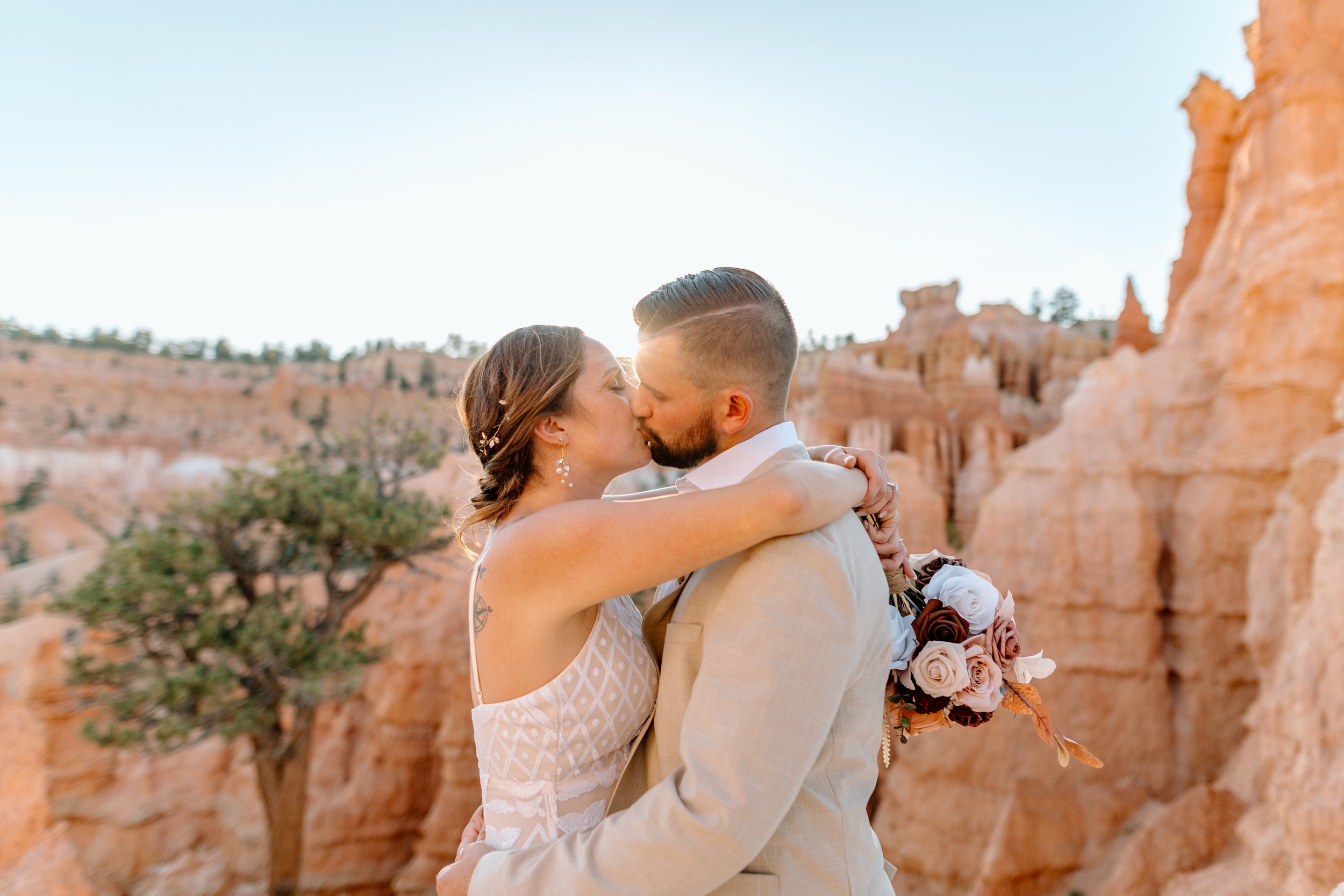  sun shines as couple kisses during their bryce canyon elopement 
