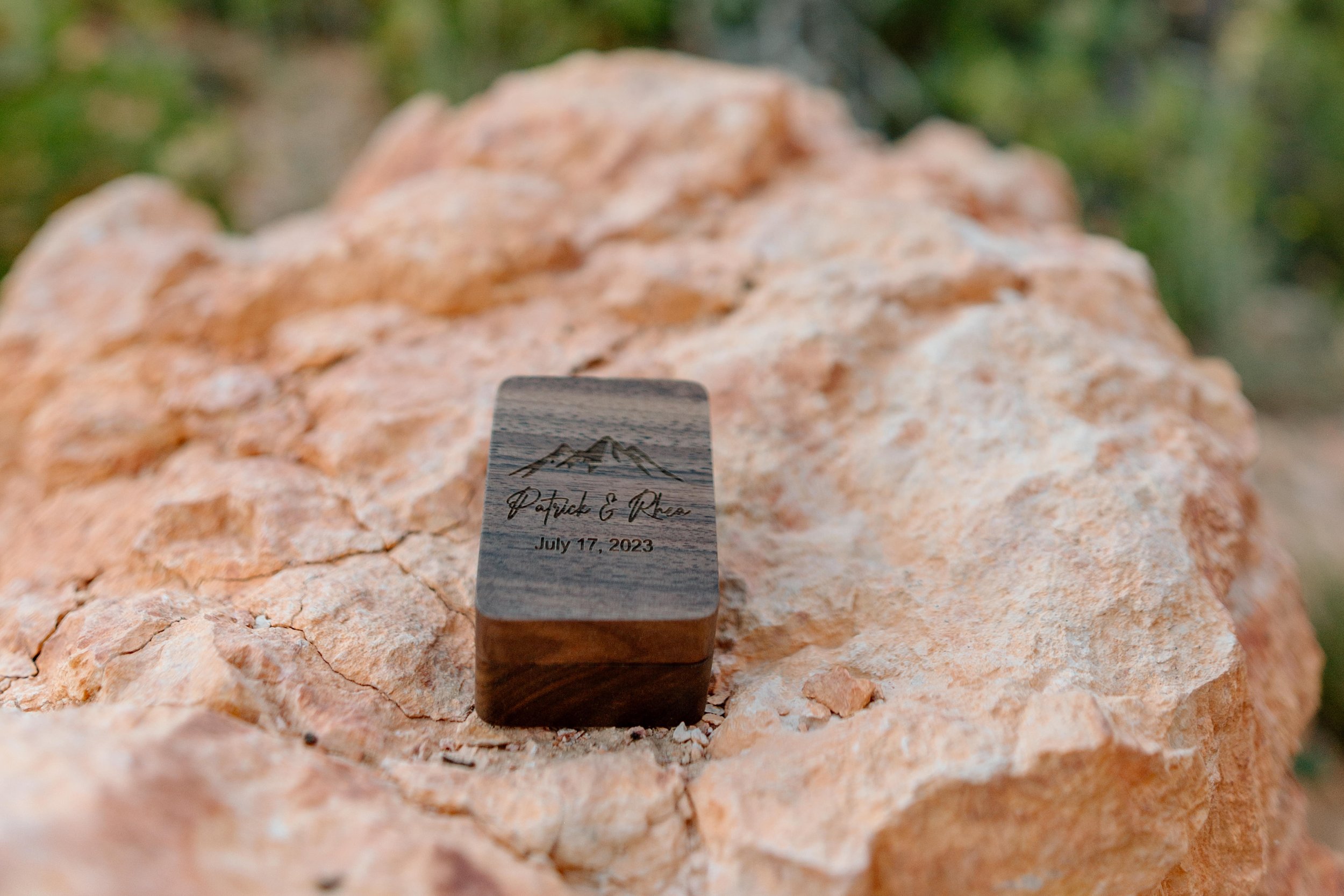  engraved ring box on an orange rock during bryce canyon elopement 