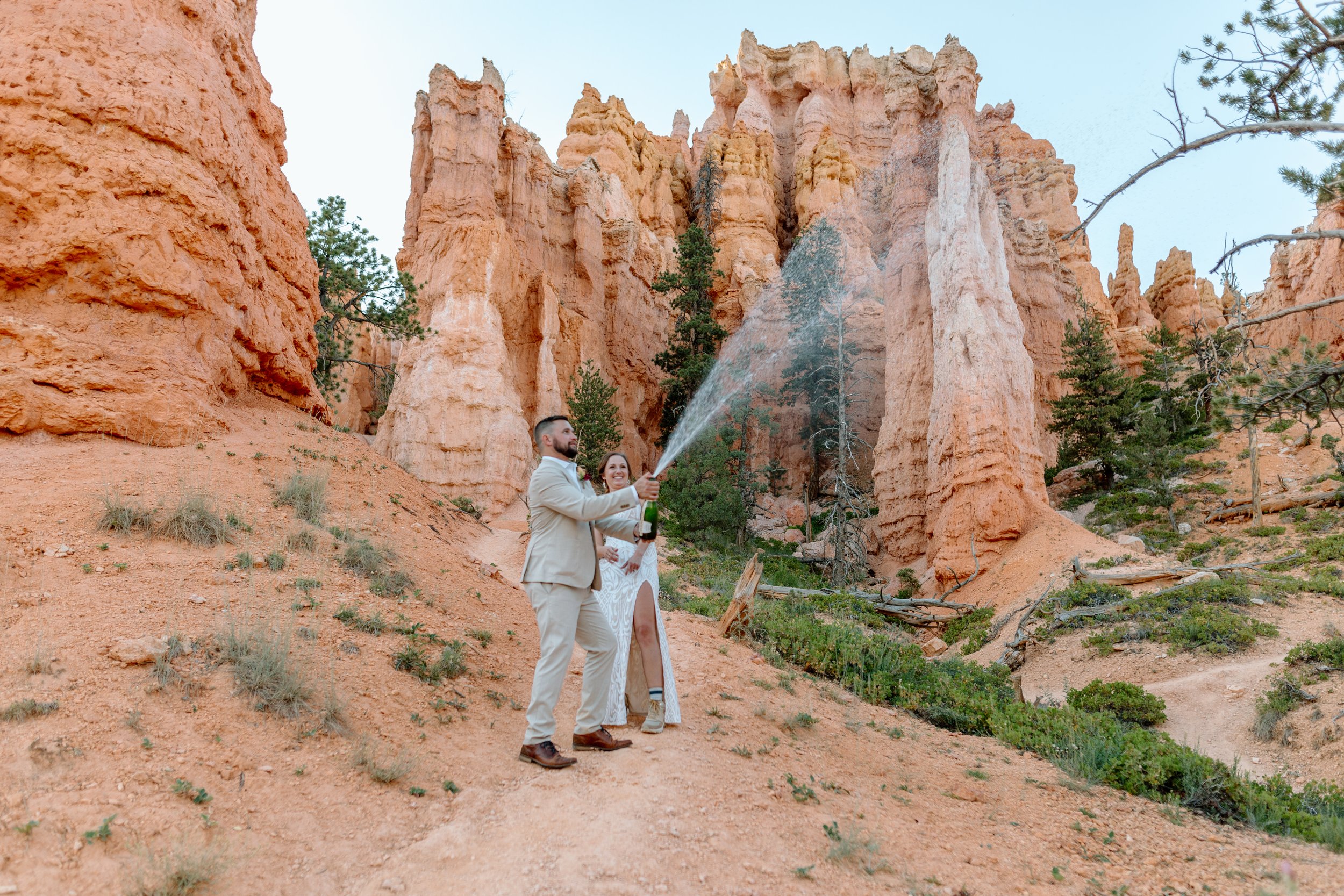  couple sprays champagne in bryce canyon national park to celebrate their utah elopement 