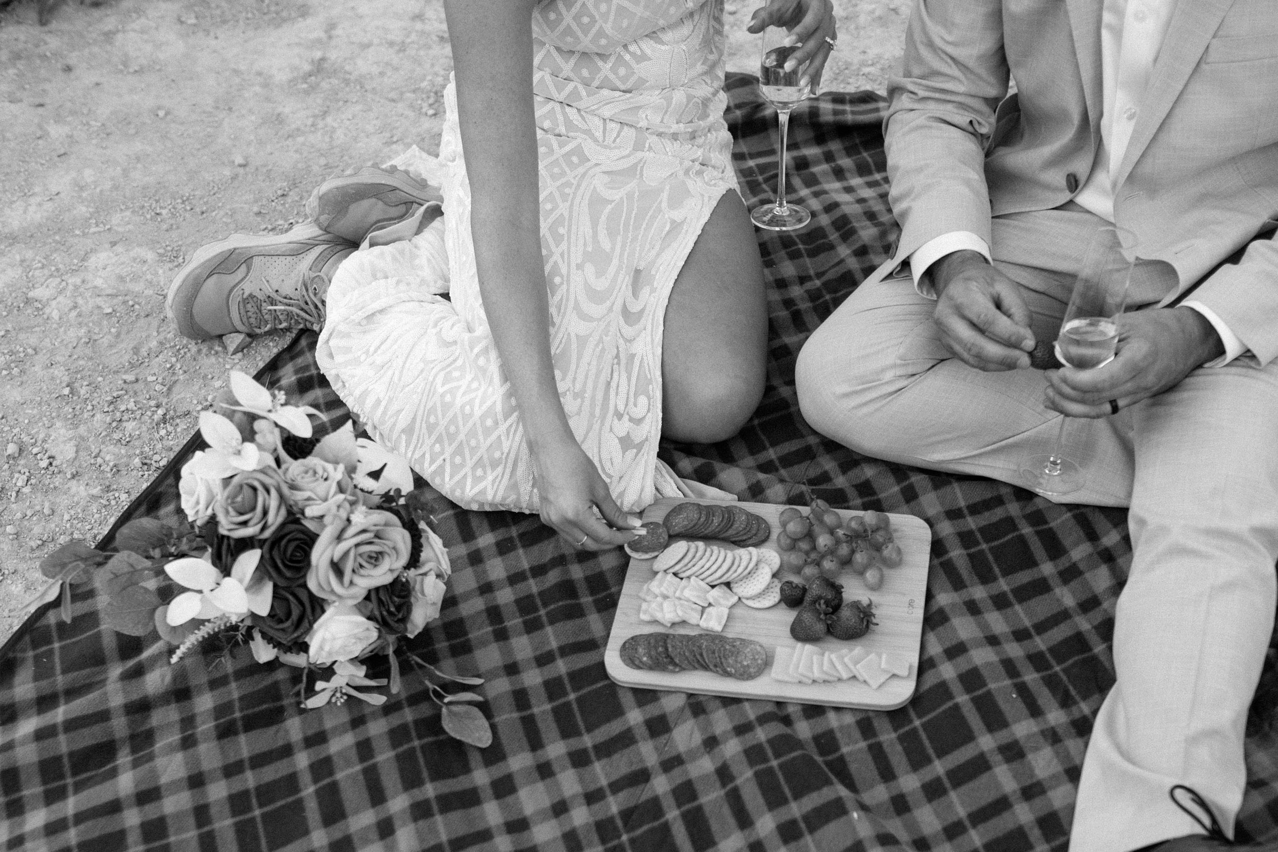  black and white photo of couple having picnic at their utah elopement 