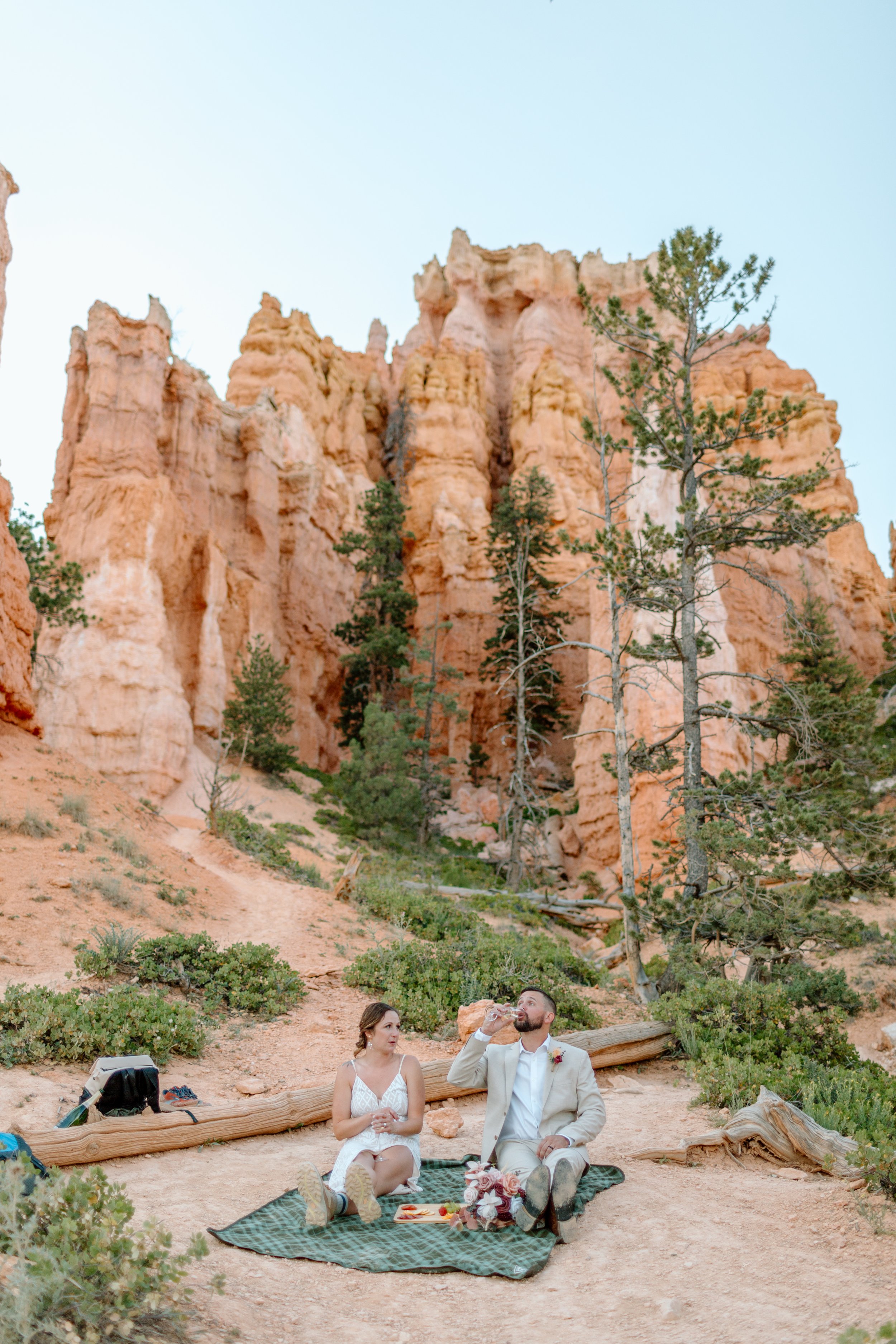  groom chugs champagne during bryce canyon elopement 