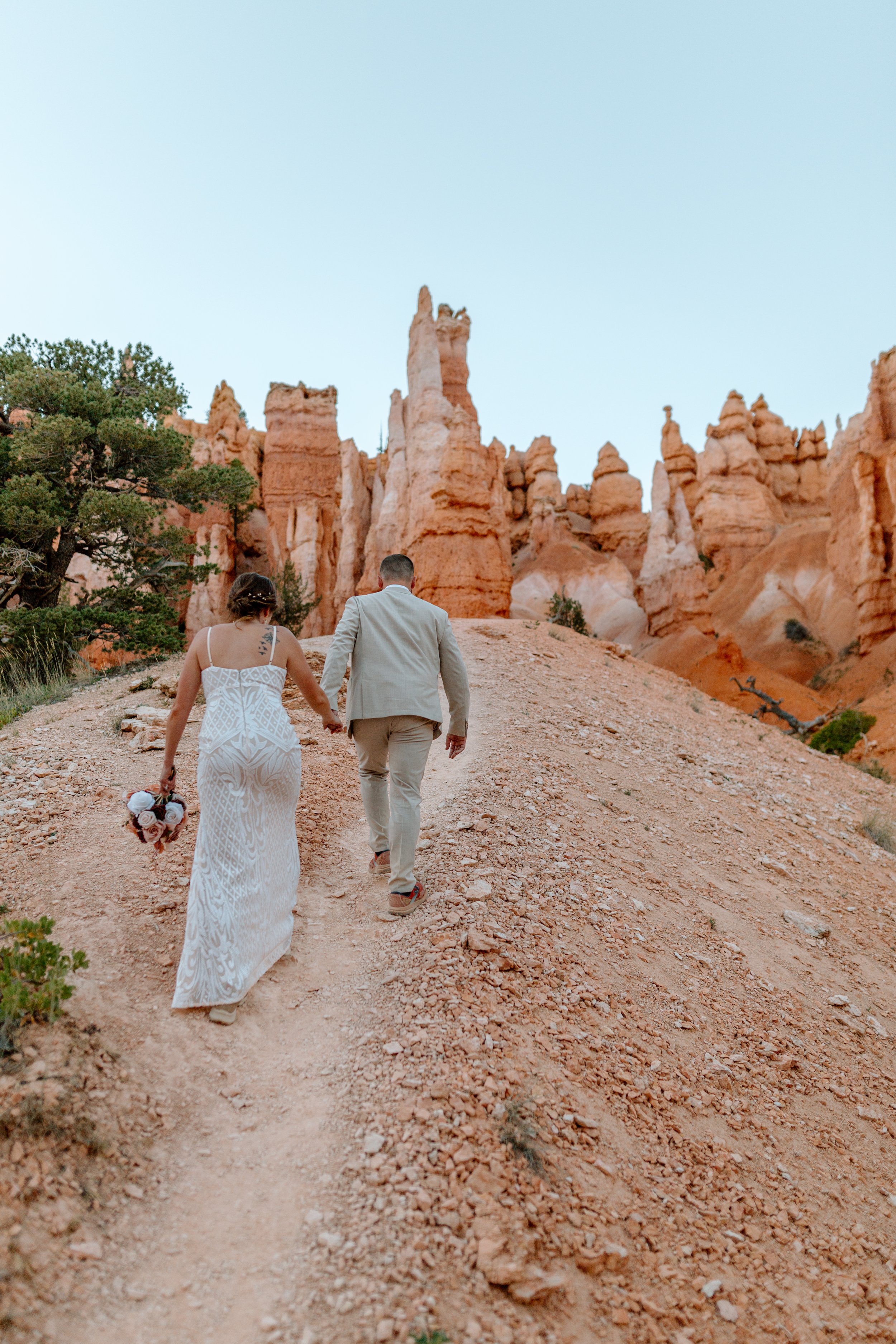  elopement couple walks an uphill trail at bryce canyon national park 