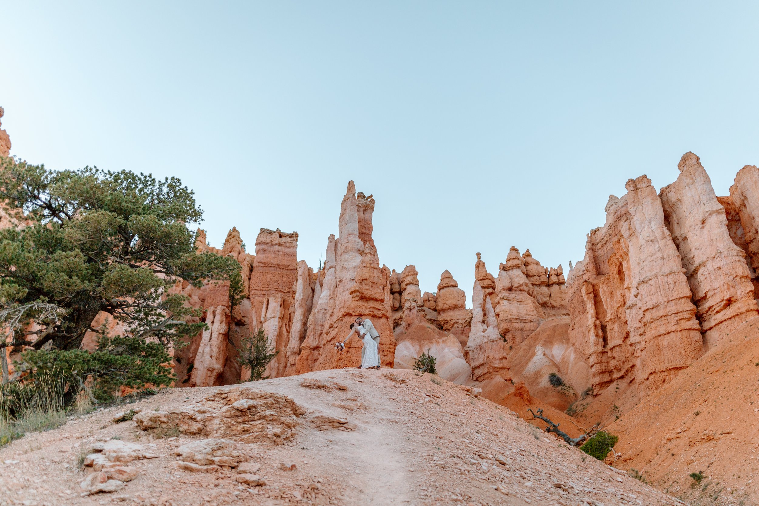  couple kisses in front of bryce canyon landscape by utah elopement photographer 