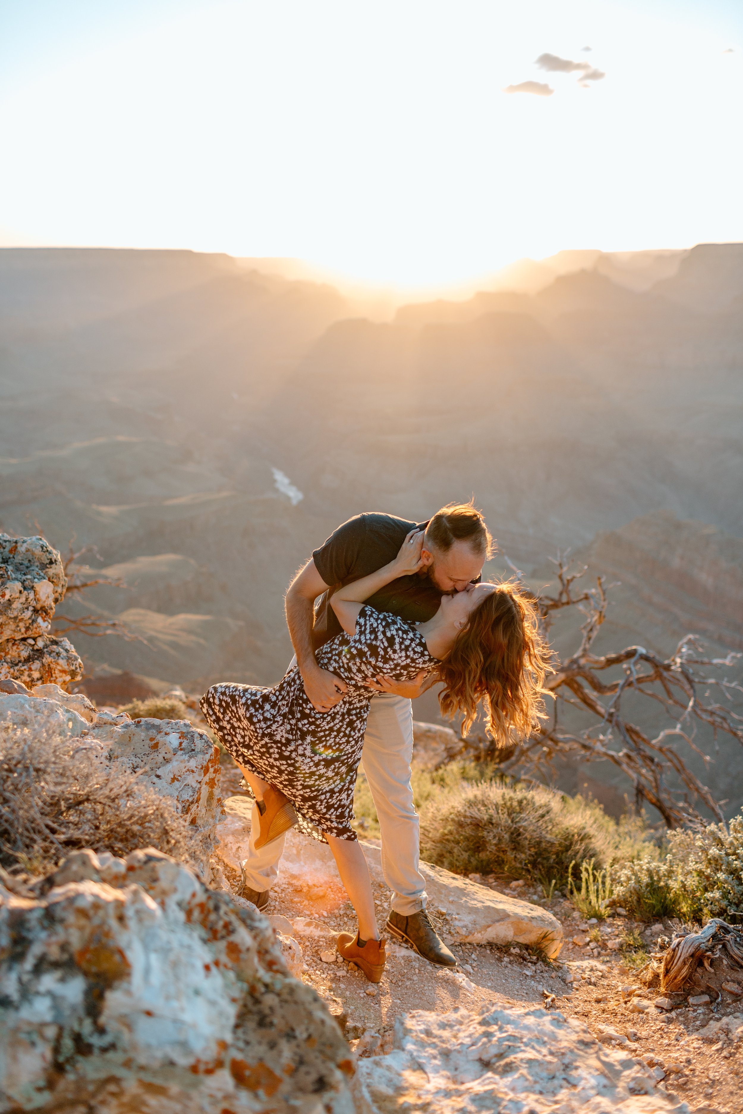  couple does a dance dip with a kiss at sunset for their grand canyon couples session 
