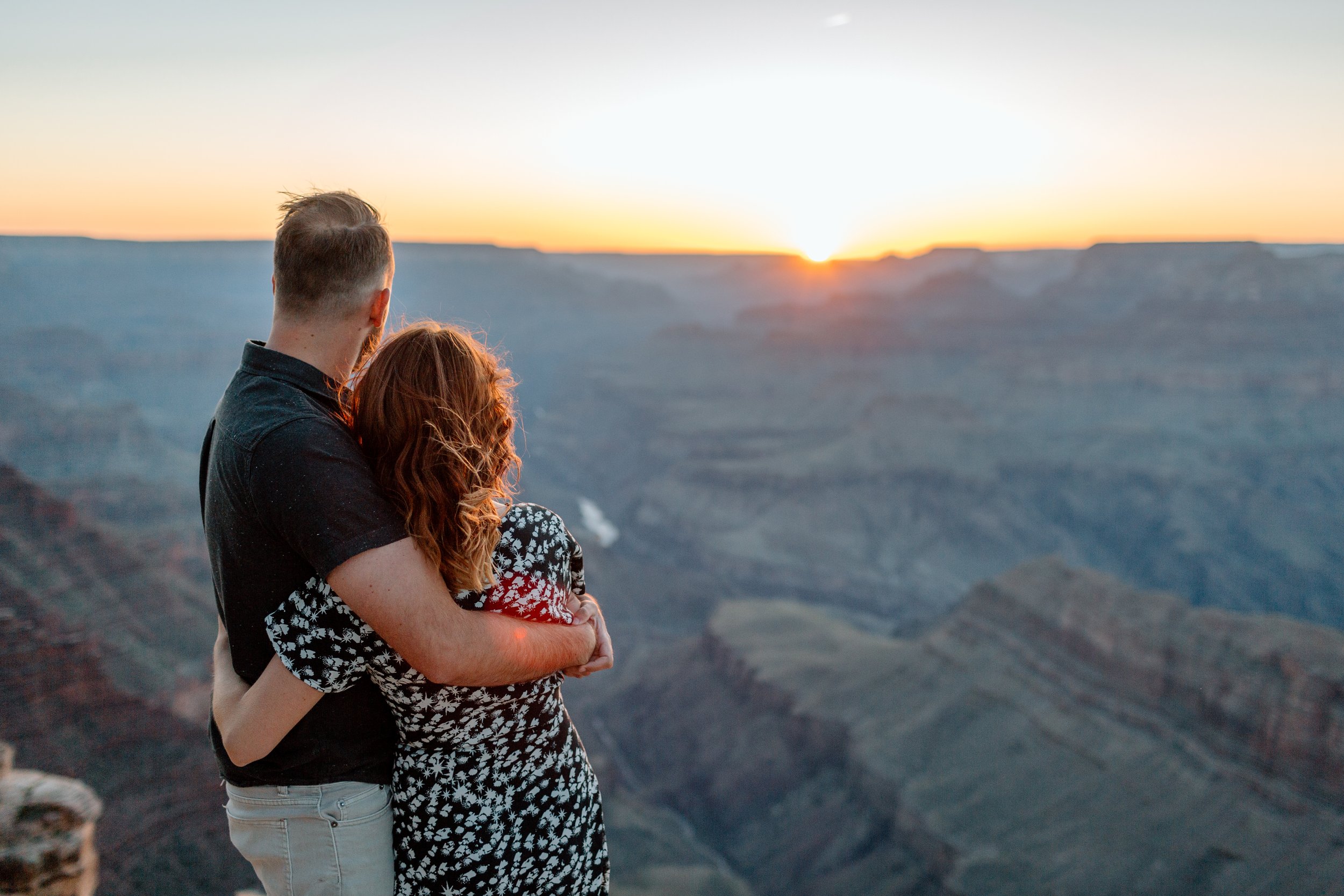  couple holds each other and enjoys sunset at lipan point for their grand canyon engagement session 