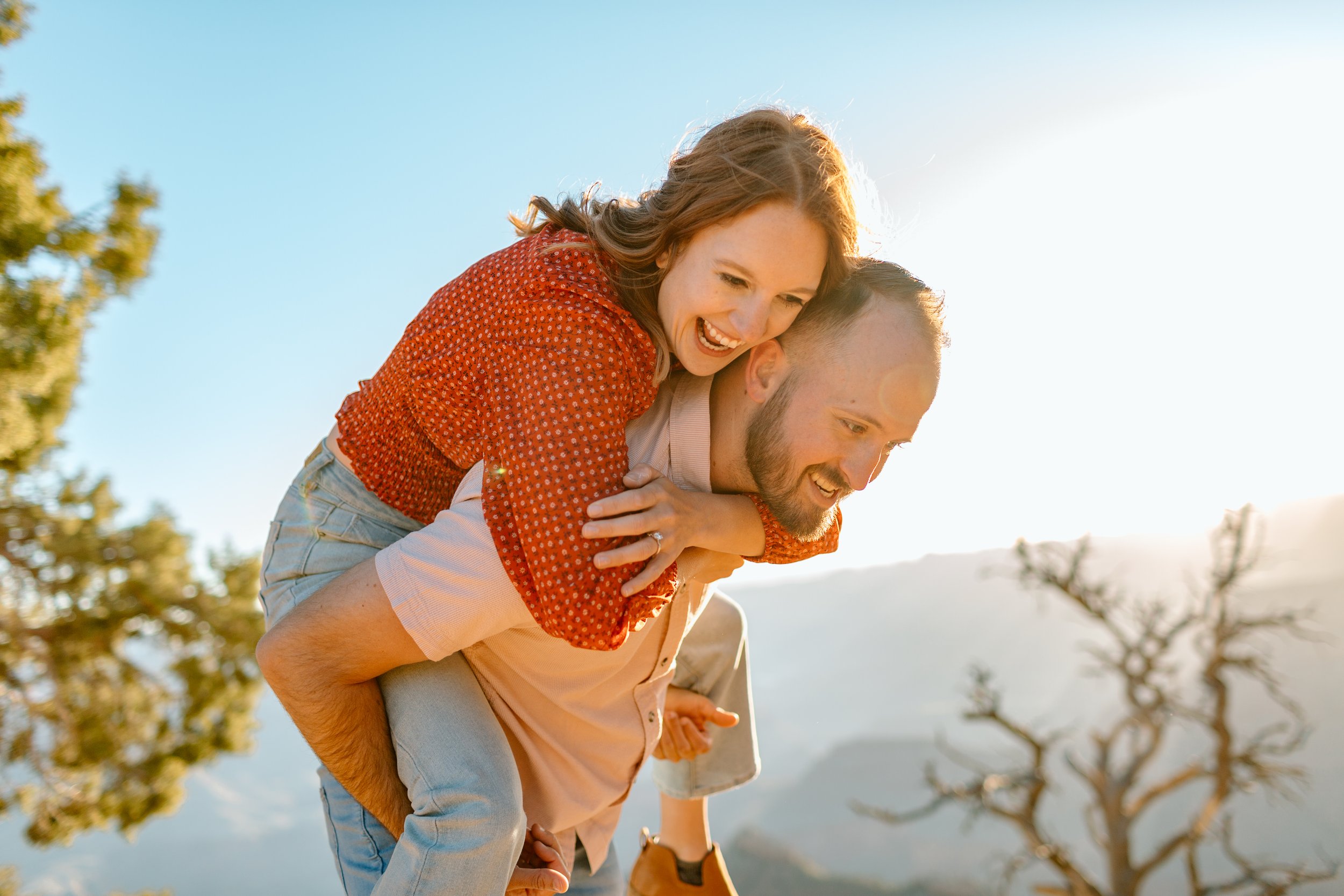  man gives woman a piggyback ride and they laugh during their arizona engagement session 