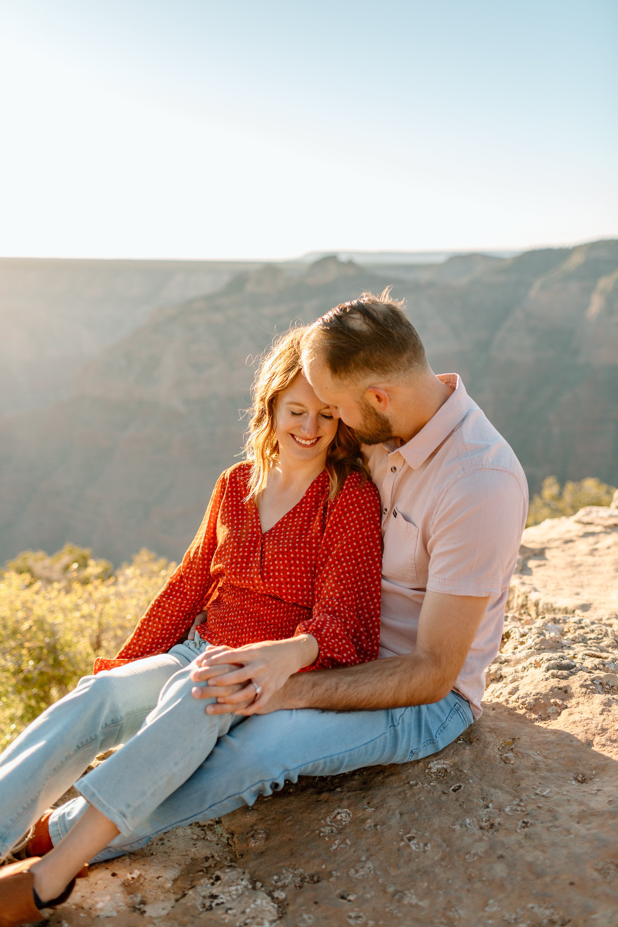  couple sits on the ground and snuggles during their arizona engagement session 