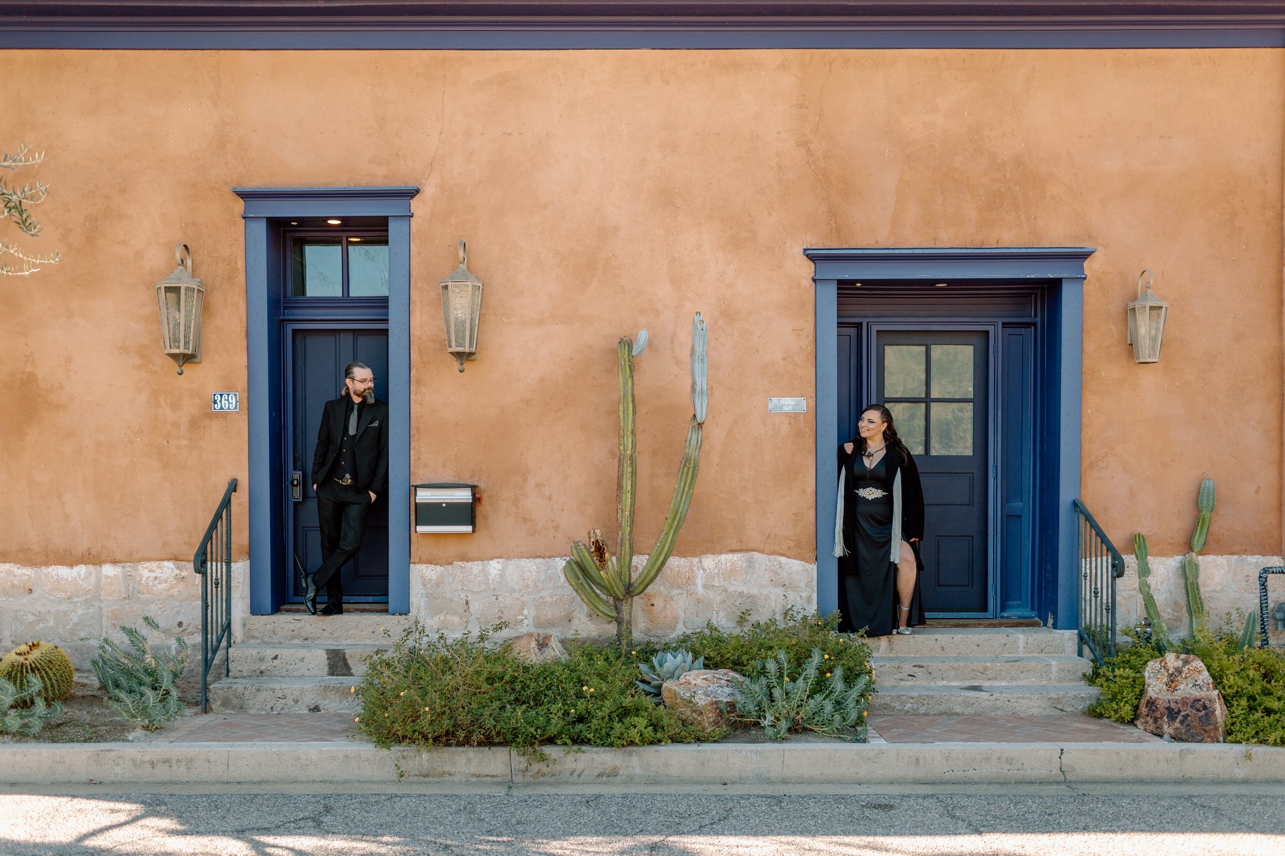  couple stands in separate doorways and look at each other during their urban tucson elopement 