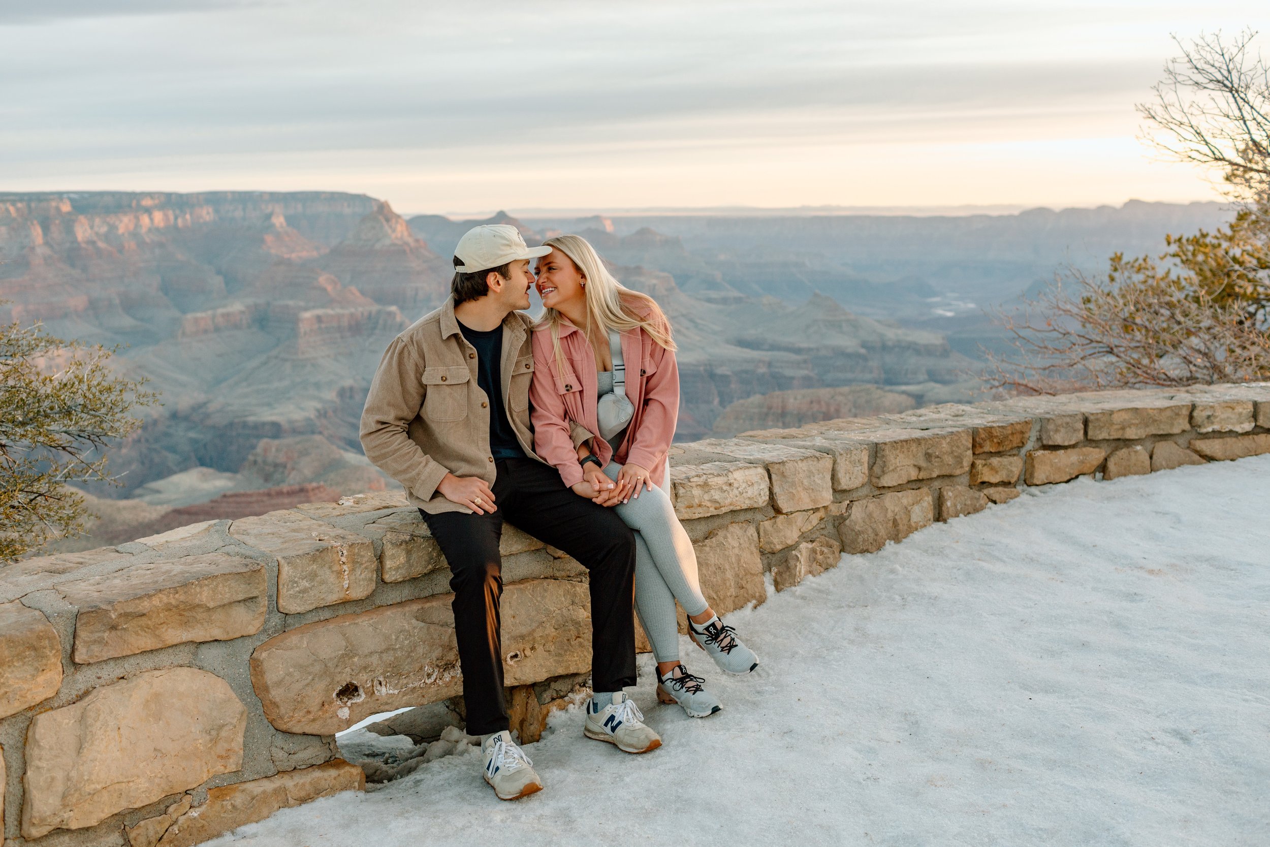  couple smiles and snuggles after their grand canyon proposal 