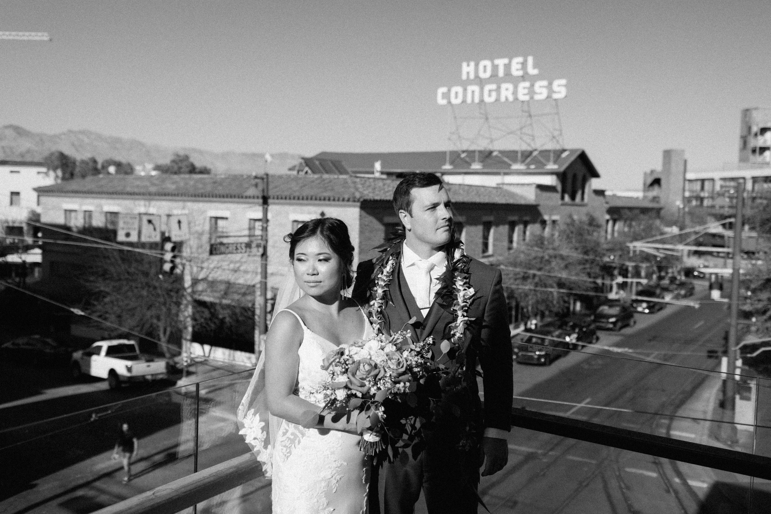  black and white photo of arizona elopement couple in downtown tucson with hotel congress in background 