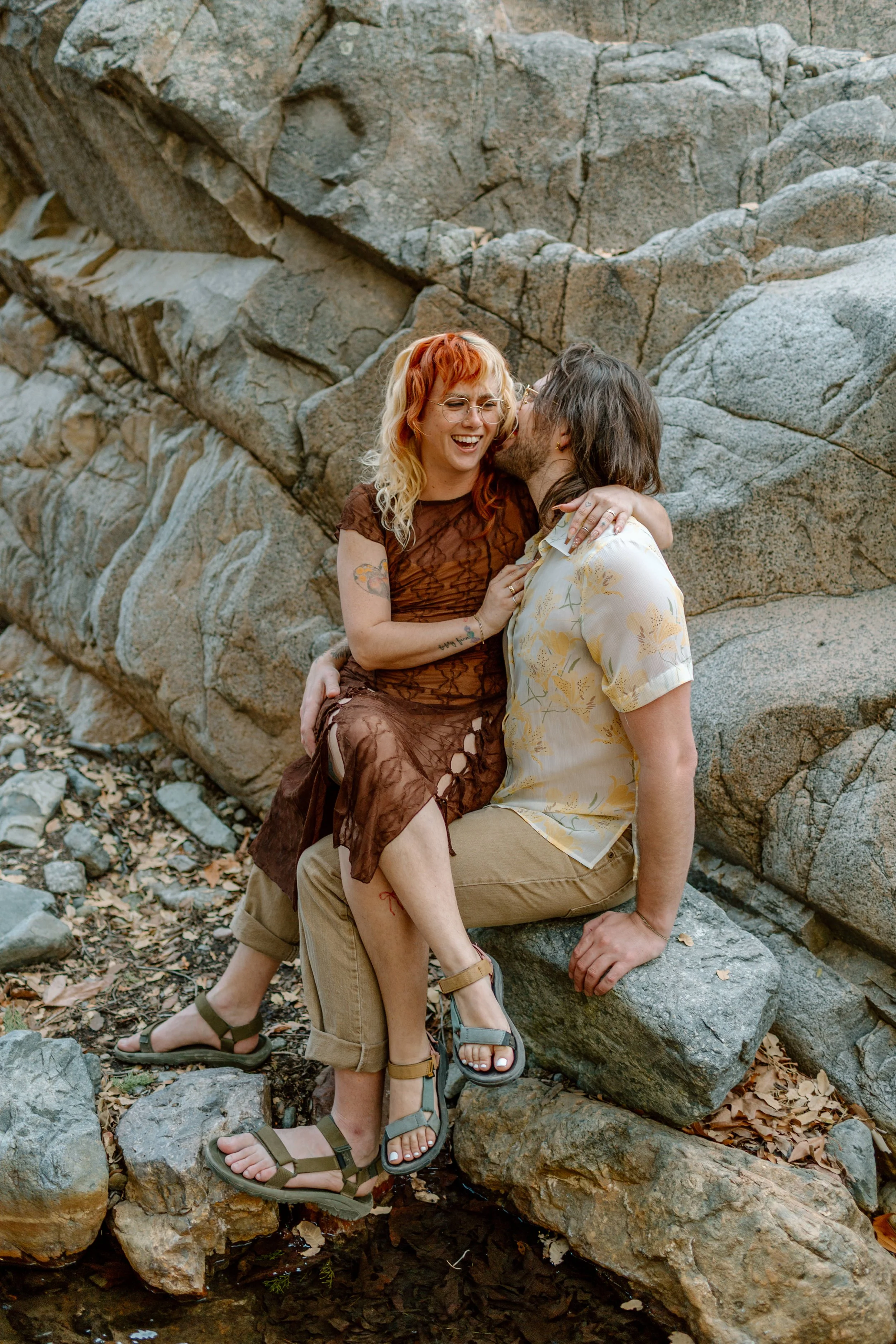  couple snuggles and laughs together during Tucson engagement session 