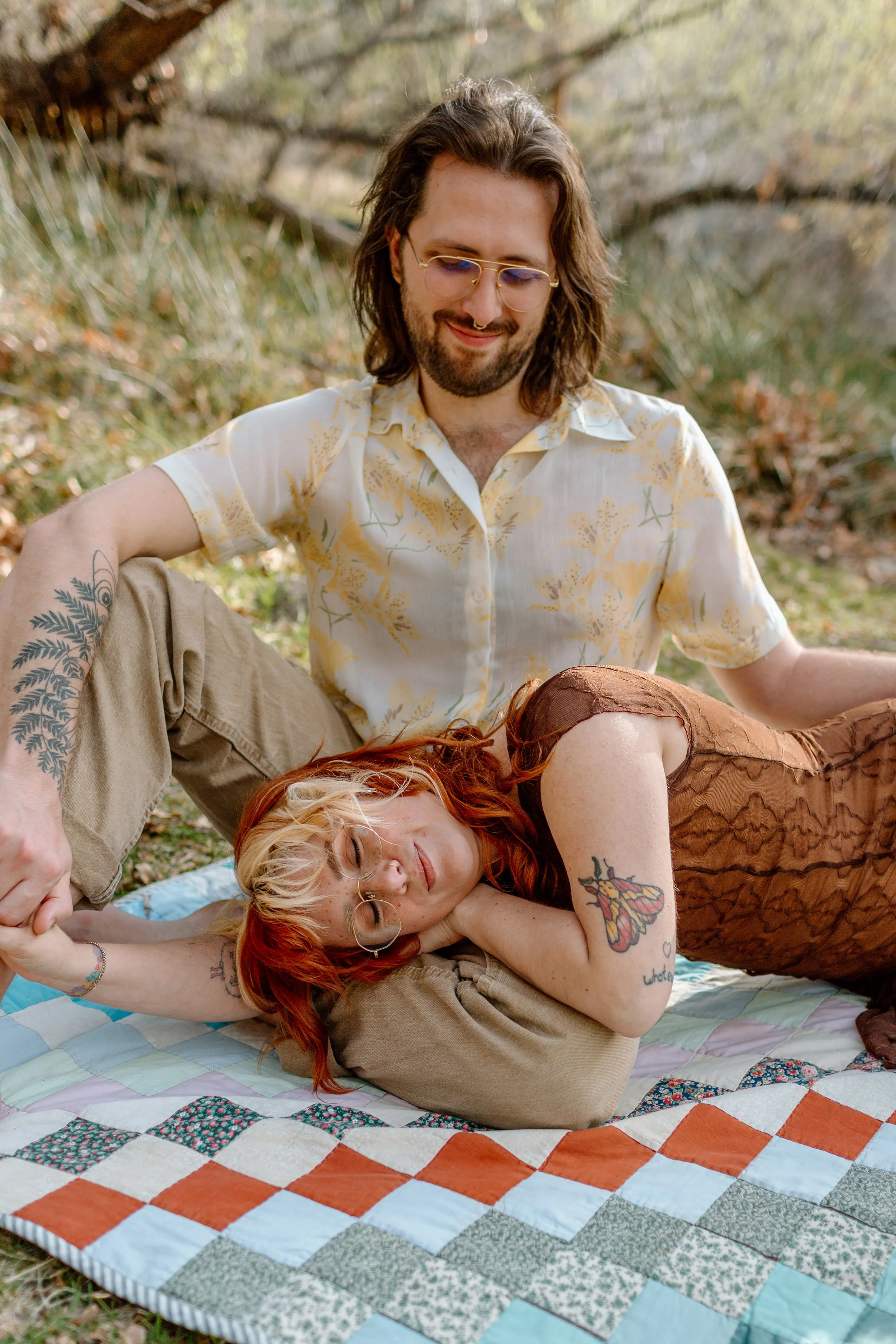  couple snuggles on picnic blanket during Tucson engagement session 