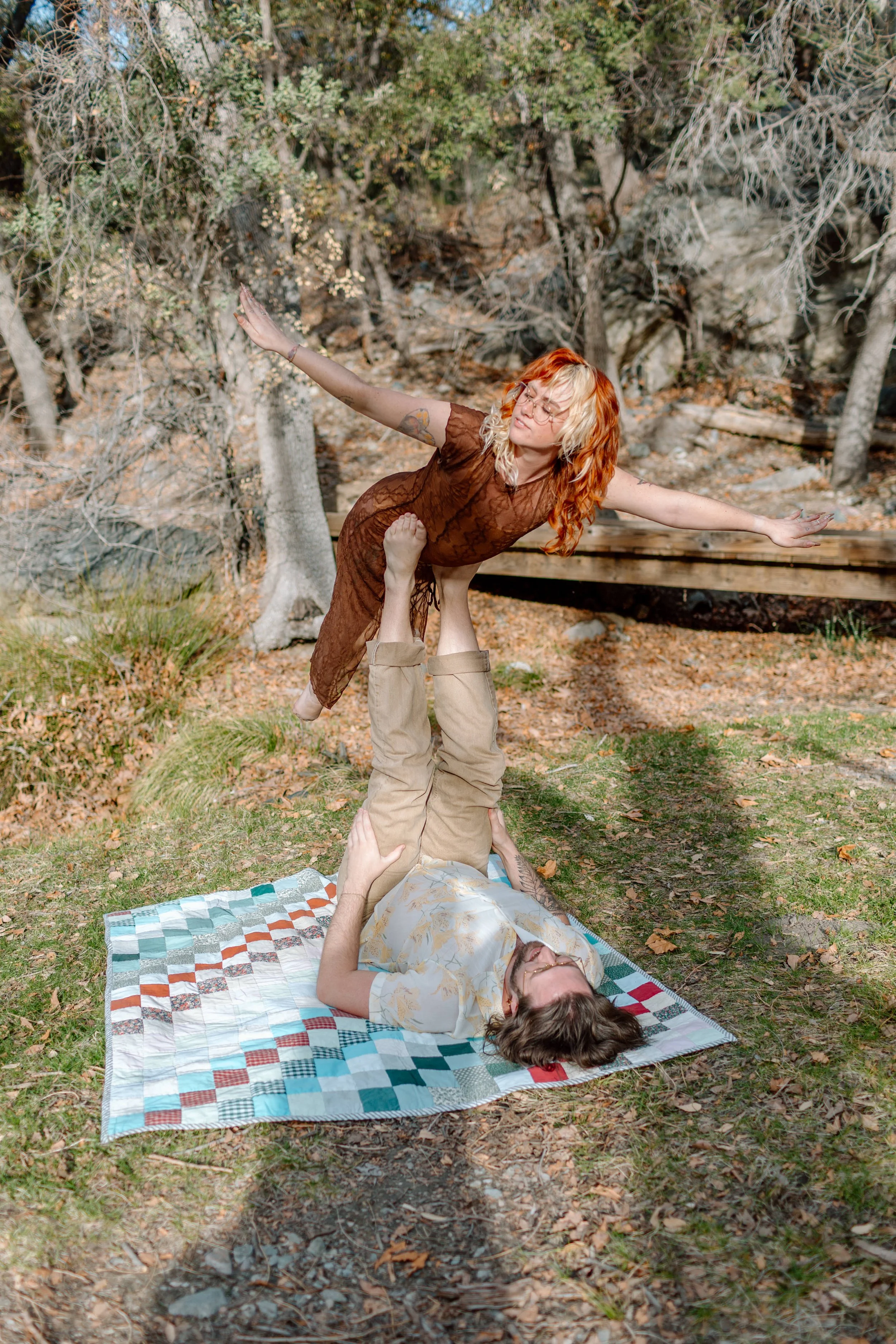  couple plays superhero on a picnic blanket by Tucson engagement photographer 