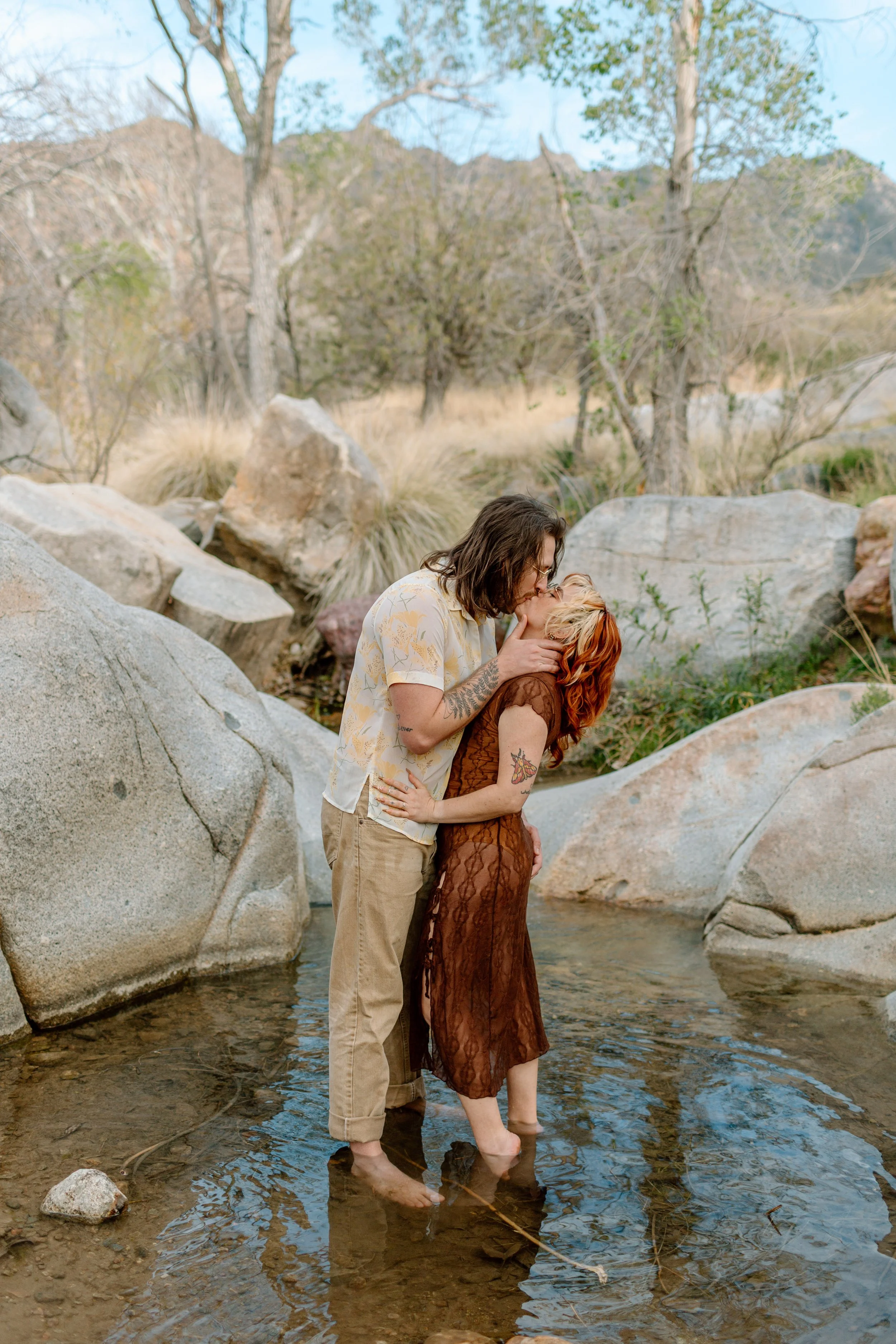  couple kisses while standing in a pool for Madera Canyon engagement session 