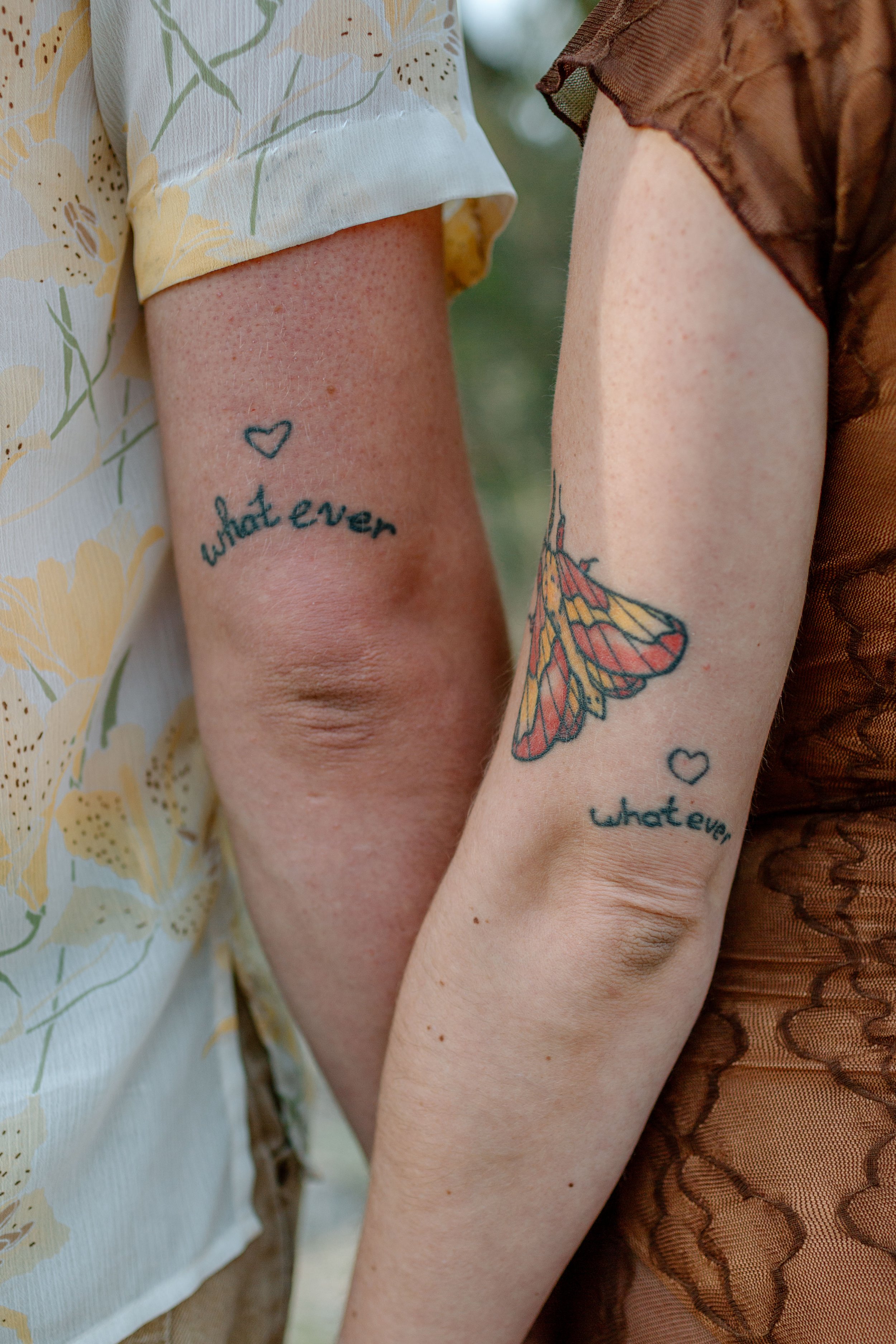  close up of couple’s matching “Whatever” tattoos during Tucson engagement session 