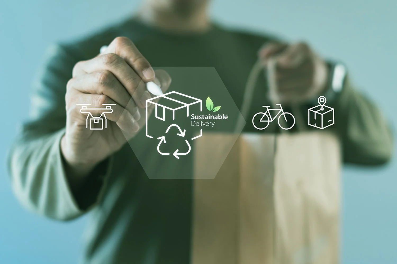 Person interacting with digital icons for drone delivery, recycling, bicycle, and package, emphasizing sustainable delivery methods.