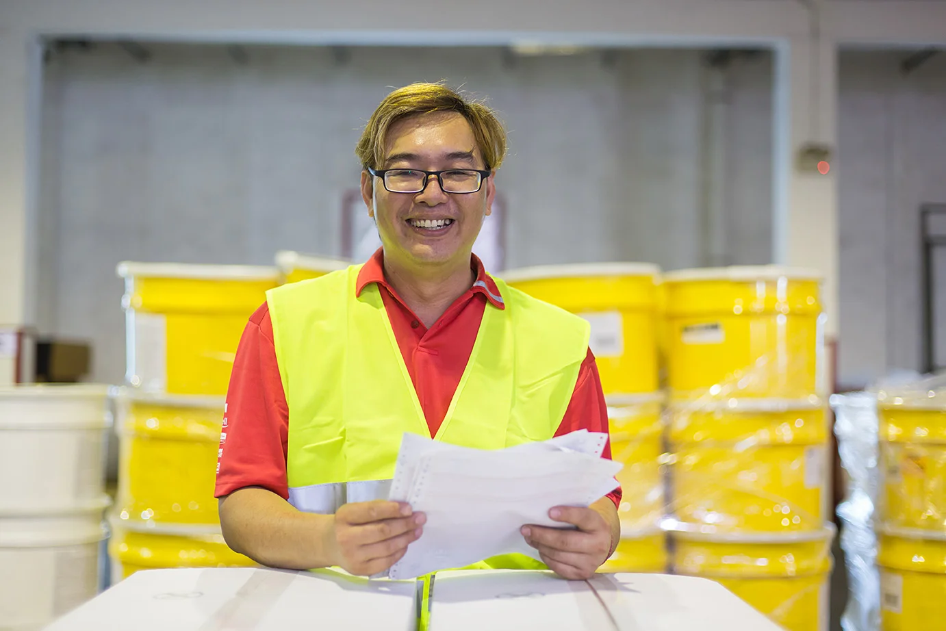 Portrait of a logistic worker holding paperwork.