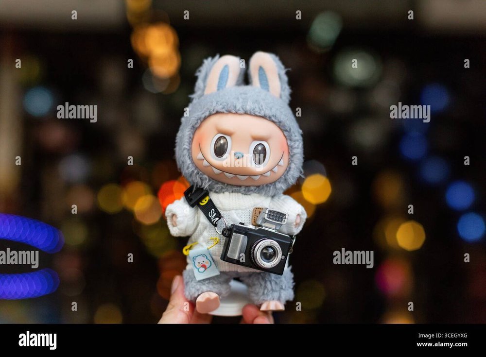 labubu-figurine-dress-up-like-a-photographer-wear-sweater-with-a-sling-camera-posing-for-picture-act-like-a-traveler-at-the-street-singapore-3CEGYXG.jpg