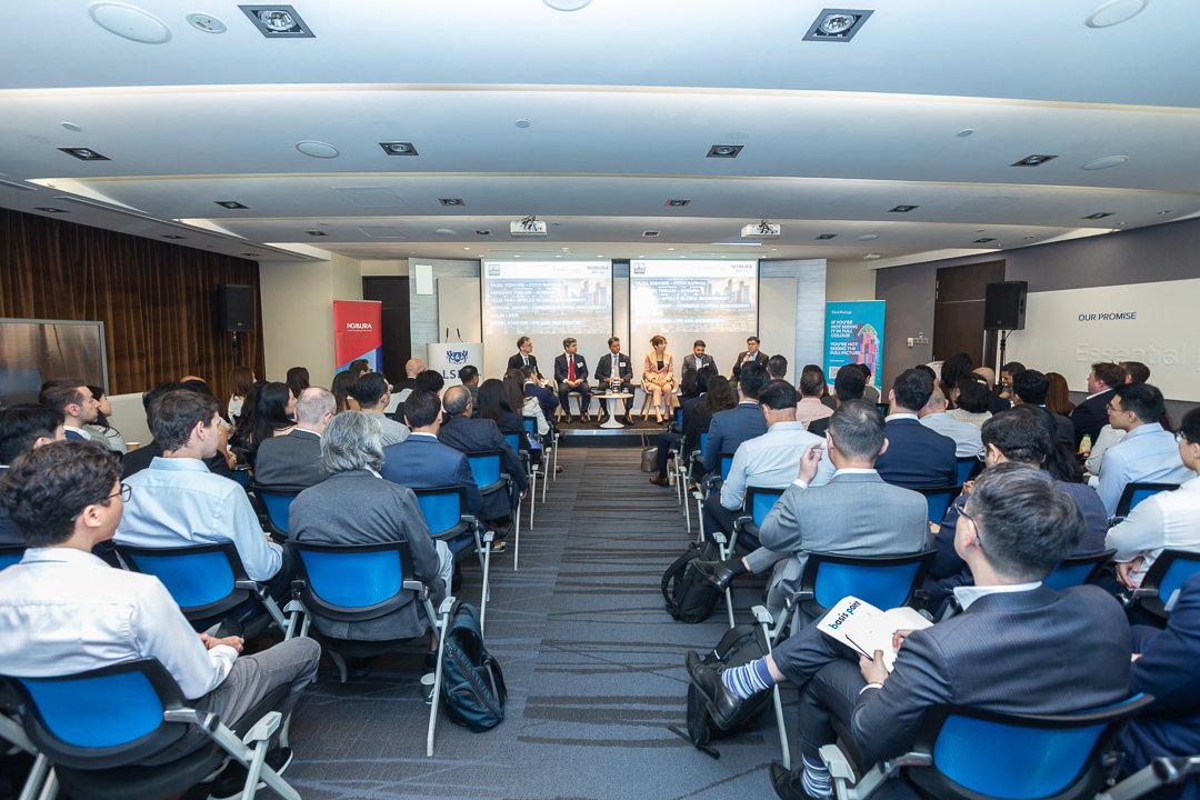 Backview of the meeting room filled with people