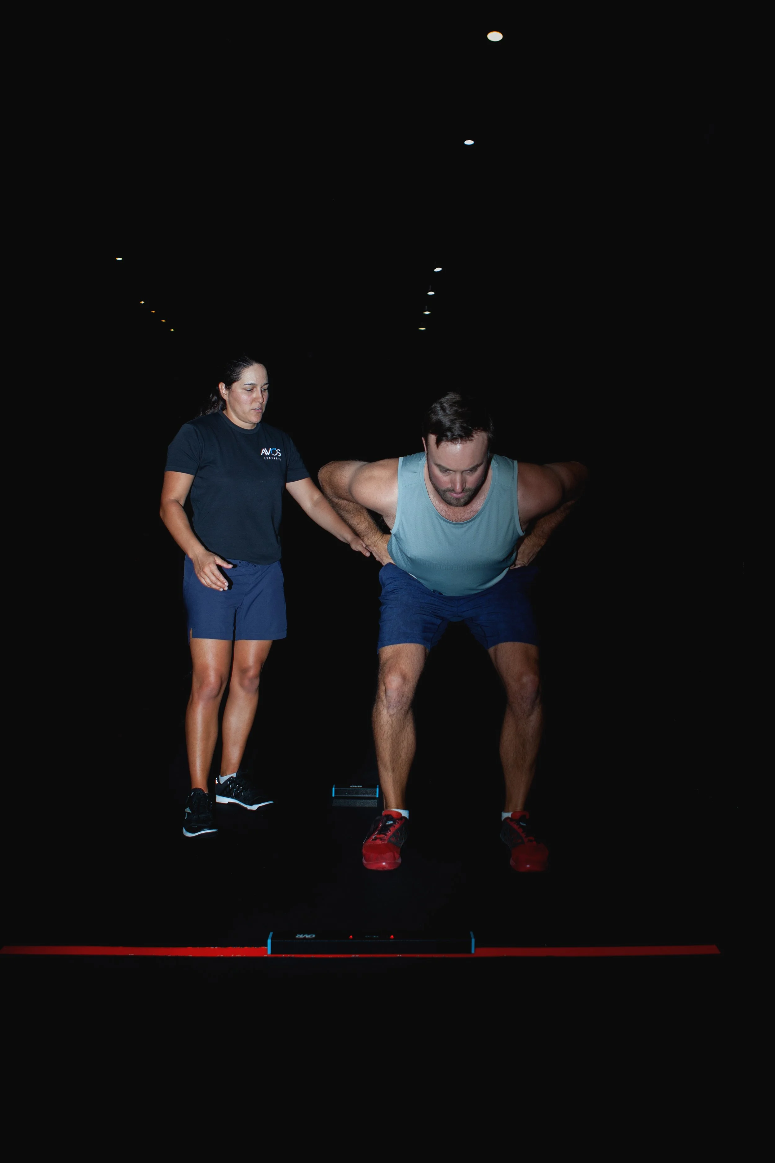 Client performing a squat jump test during Avos Performance Battery testing in Vancouver